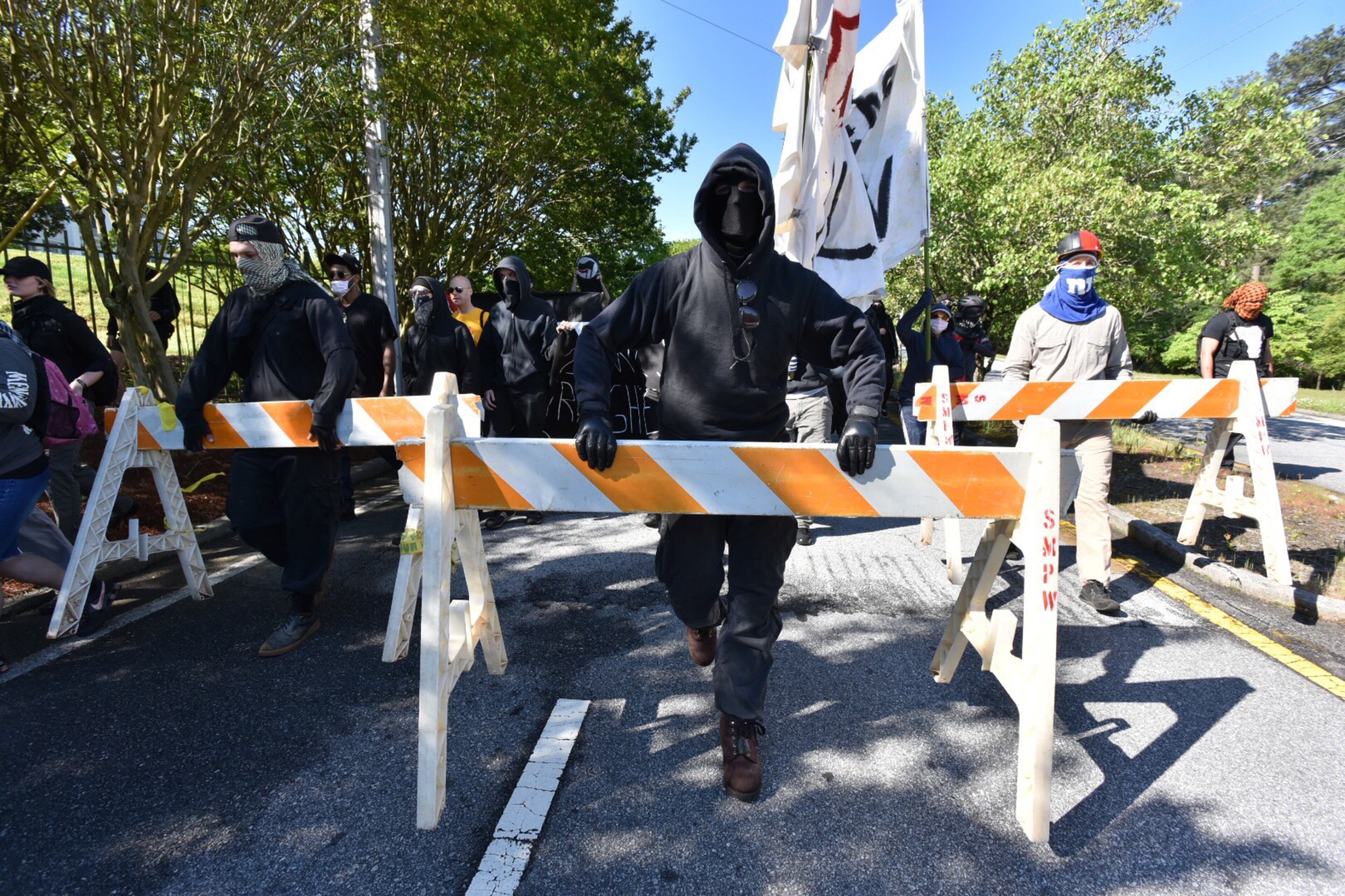 Protesters clash with police near a “white power” rally in Stone Mountain on Saturday, April 23, 2016. The protesters said they are opposing the message of hate at the supremacist rally also taking place at the park.