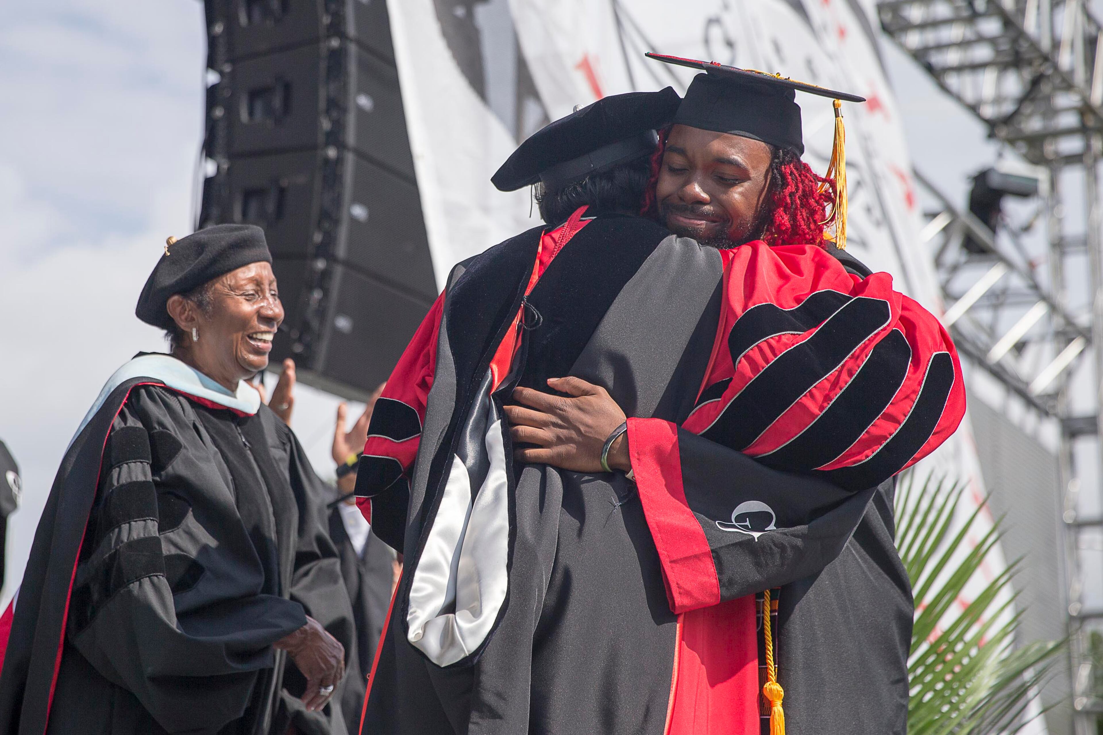 5/20/2019 -- Atlanta, Georgia -- Clark Atlanta University Valedictorian Keymani Reid receives a hug from Interim President Lucille Mauge after receiving his degree during Clark Atlanta University's 30th annual commencement ceremony at Panther Stadium in Atlanta, Monday, May 20, 2019. (Alyssa Pointer/alyssa.pointer@ajc.com)