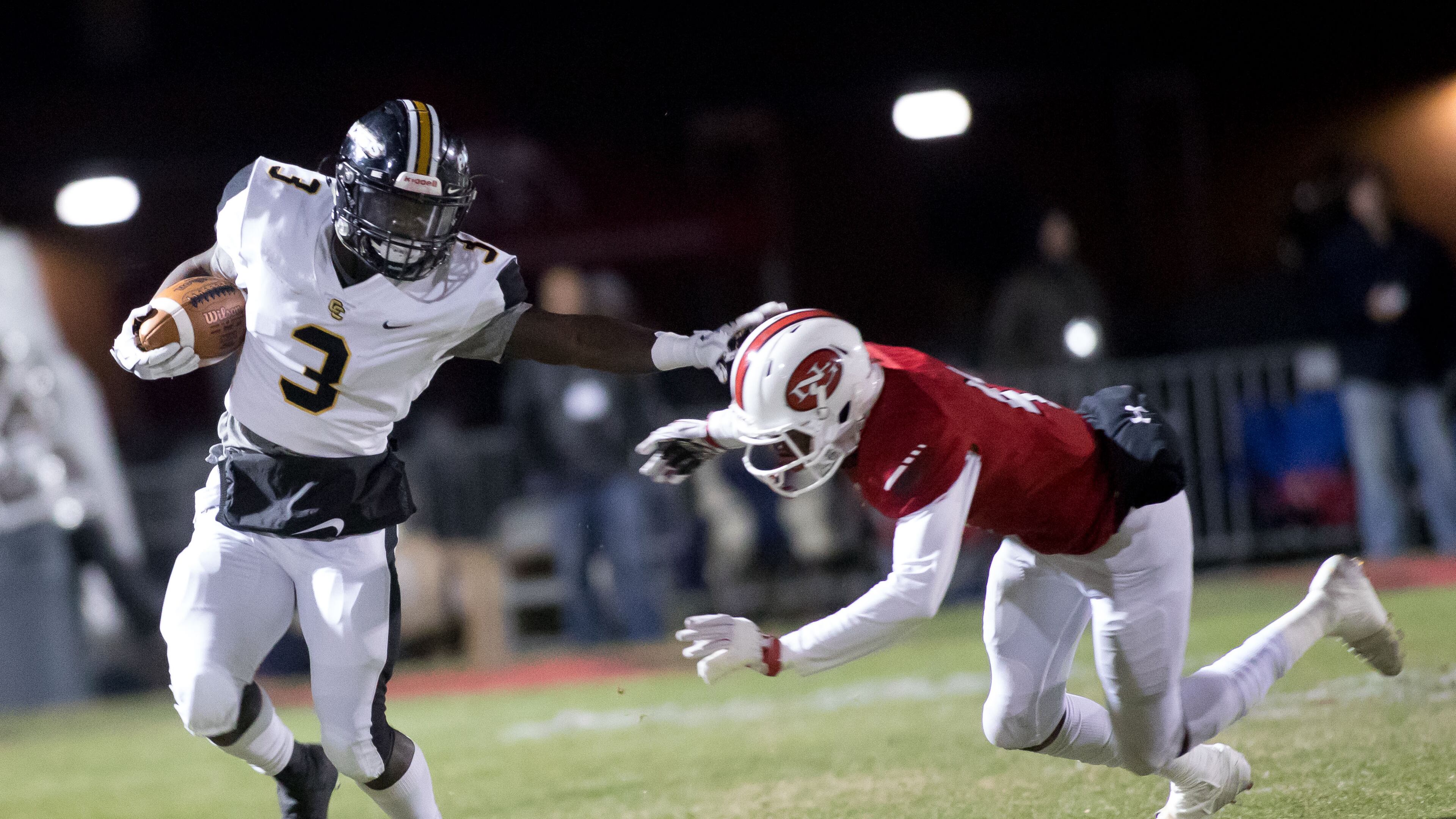 Colquitt County's Daijun Edwards (3) avoids tackle by a North Gwinnett High School player during a Class AAAAAAA football championship game, Friday, Dec. 15, 2017, in Suwanee, Ga.