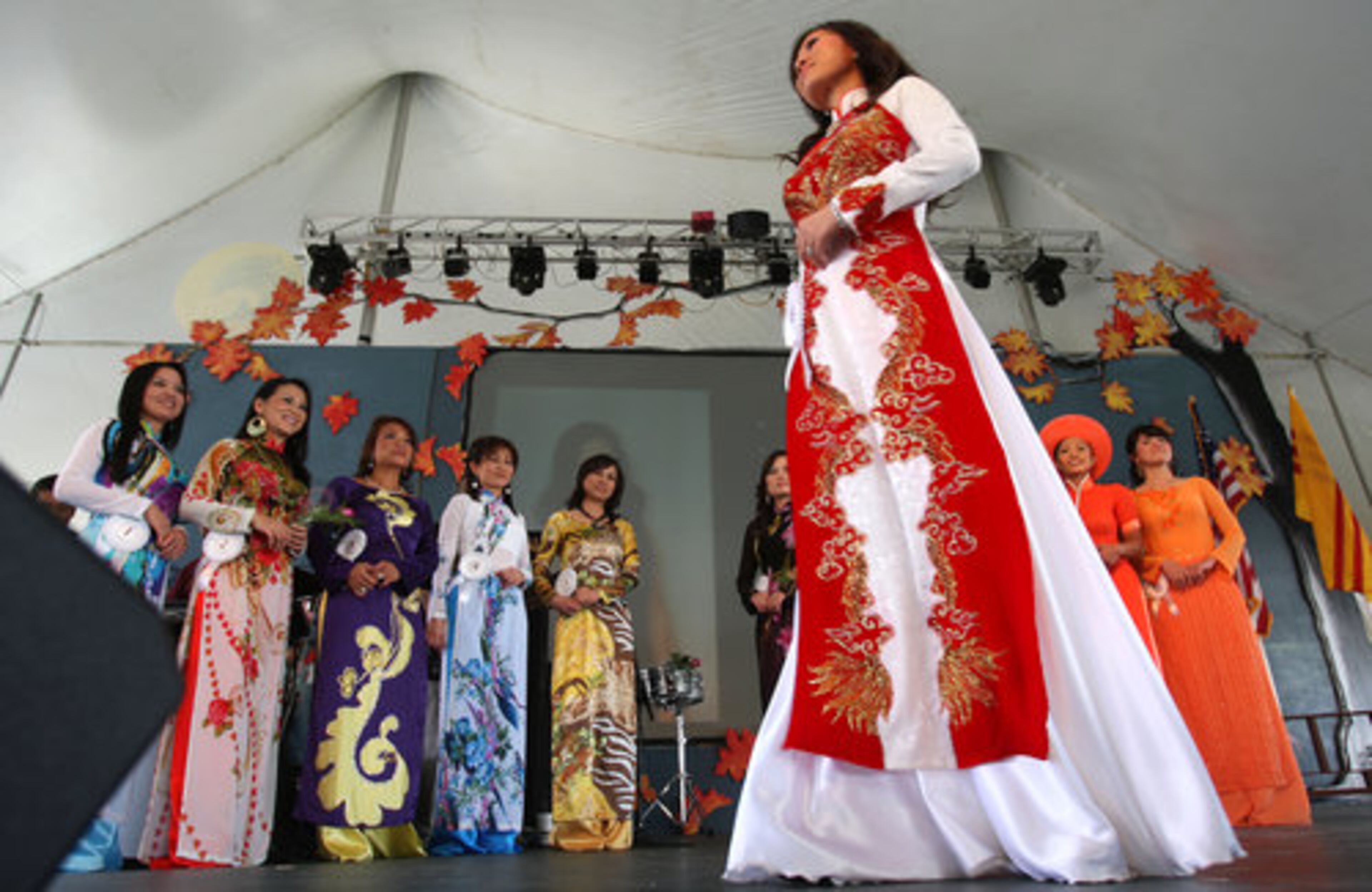 Van Le Huynh walks the stage with her silk tunic ao dai, a Vietnamese national costume, during the first round of the traditional dress contest during The Holy Martyrs of Vietnam Catholic Church's 2nd Annual Fall Festival in Norcross Sunday, September 5, 2010. Ao dai invokes nostalgia and timelessness and is associated with the image of their homeland. The winner of the contest will take home the prize money of $800.