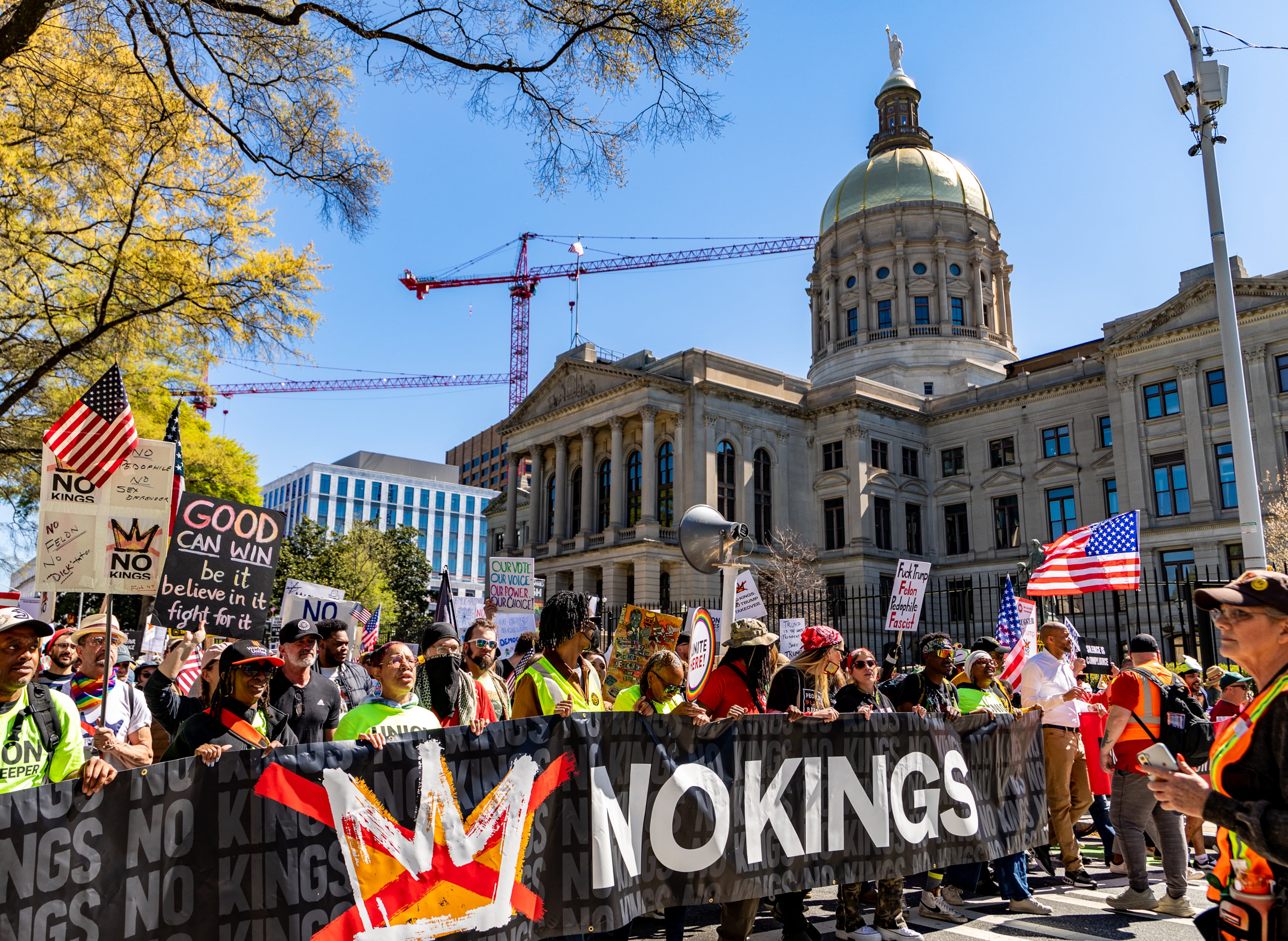 Demonstrators march in front of the state Capitol during the No Kings protest on Saturday, March 28, 2026, in Atlanta. (Jenni Girtman for the AJC)