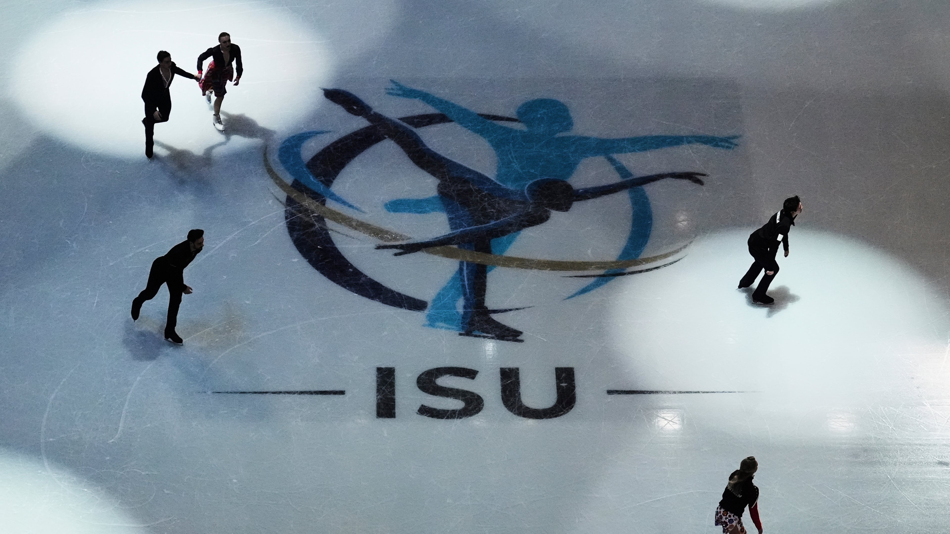 FILE - Skaters warm up before performing during the ice dance rhythm dance program at the figure skating world championships, Friday, March 28, 2025, in Boston. (AP Photo/Charles Krupa, File)