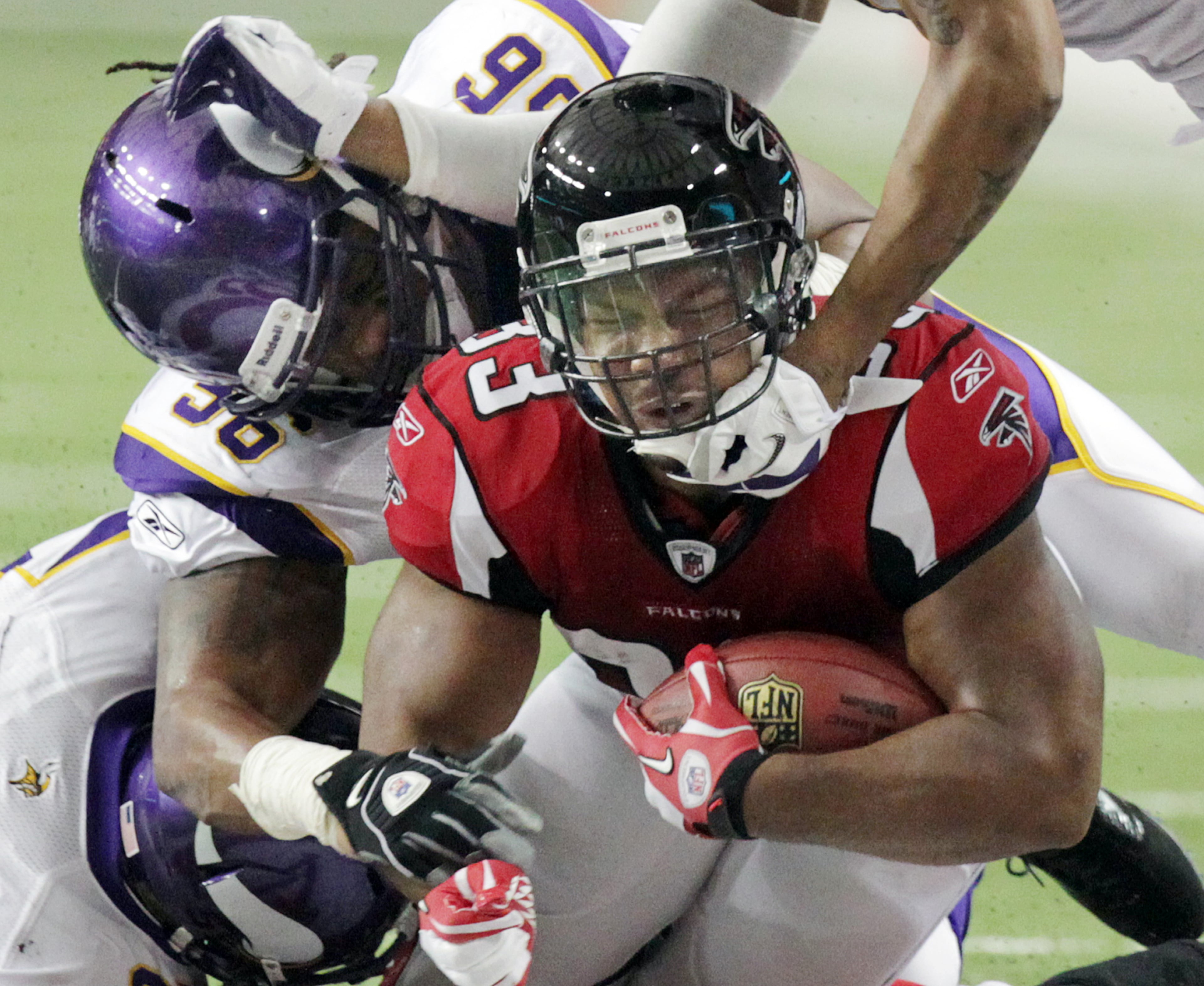 Nov. 27, 2011 - Atlanta: Falcons running back Michael Turner picks up some hard fought yardage against the Vikings as he is tackled by linebacker E.J. Henderson during 1st half action at the Georgia Dome in Atlanta on Sunday, Nov. 27, 2011. Curtis Compton ccompton@ajc.com