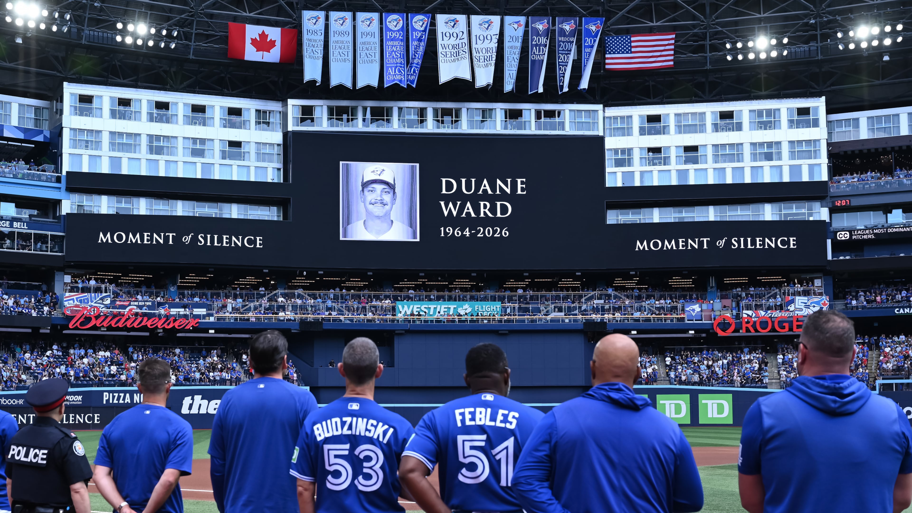Players and coaches of the Toronto Blue Jays recognize a moment of silence on the announcement of the passing of former Blue Jays pitcher Duane Ward prior to the start of the game against the Chicago White Sox in MLB baseball action in Toronto on Sunday, July 19, 2026. (Jon Blacker/The Canadian Press via AP)