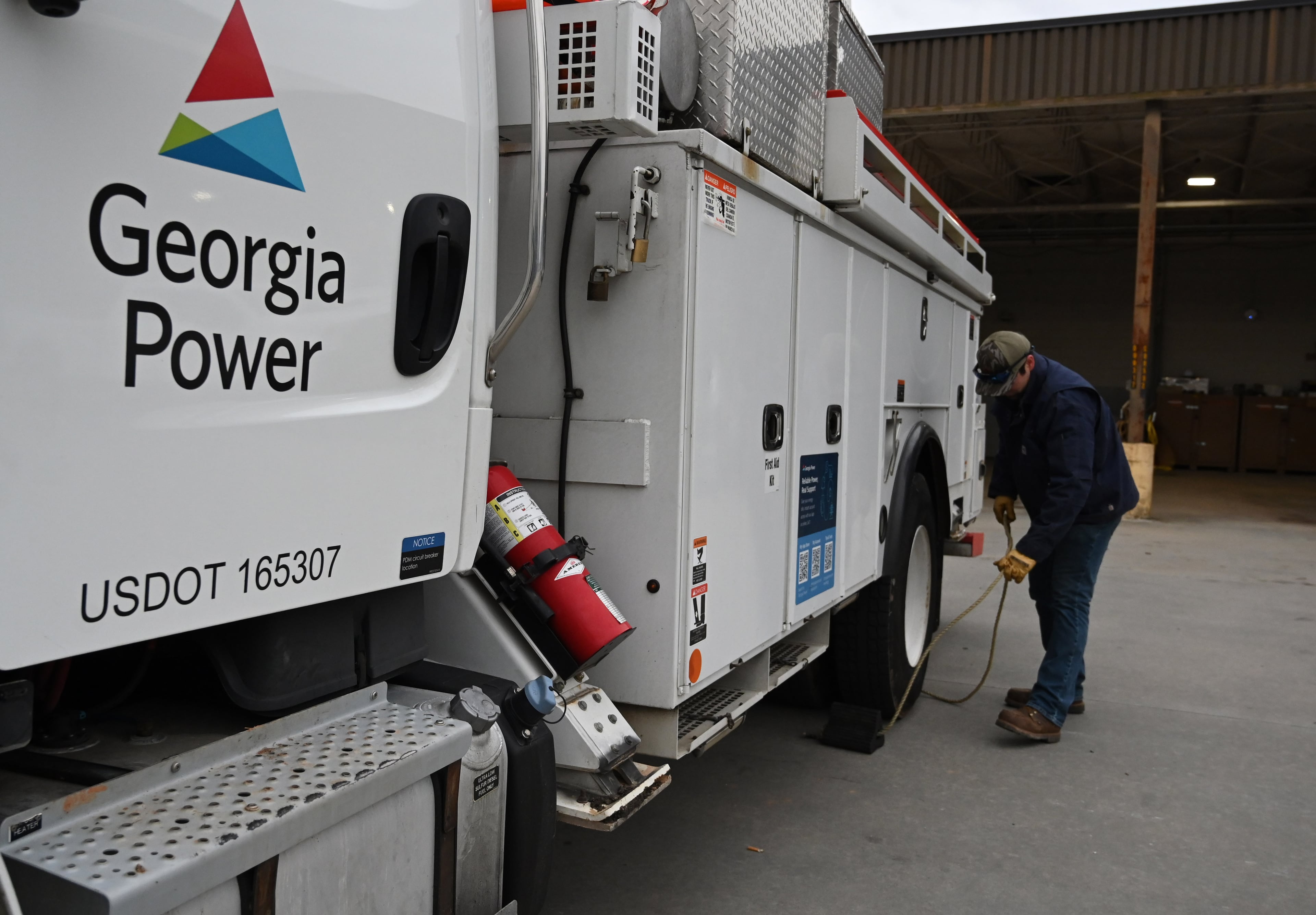 Austin Brown, with Georgia Power, prepares his truck at Georgia Power North Shallowford Operating Headquarters, Saturday, Jan. 24, 2026, in Atlanta. In metro Atlanta, an ice storm warning went into effect at 1 p.m. Saturday. It’s expected to last until Monday morning, the National Weather Service said. (Hyosub Shin/AJC)