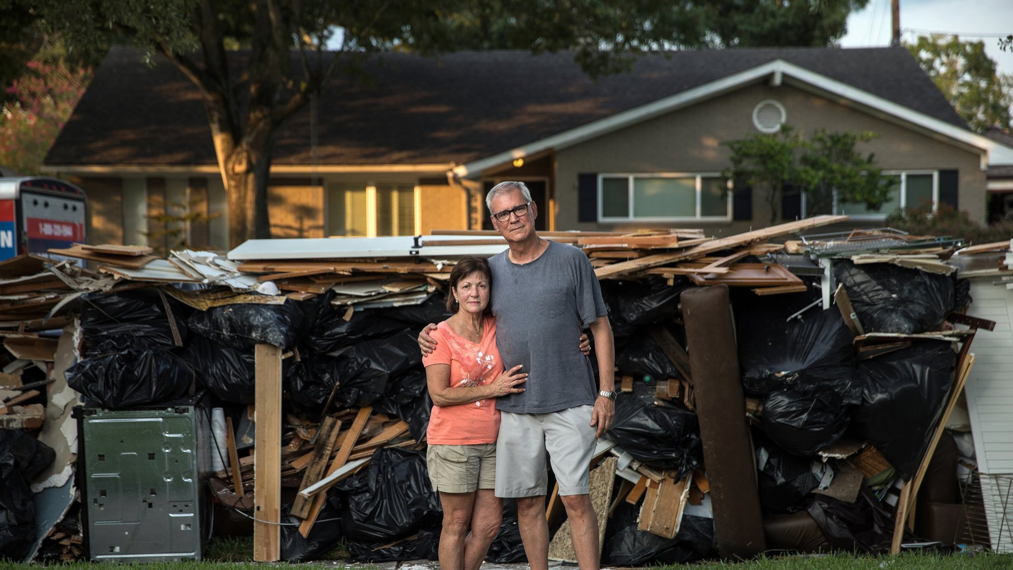 John Walton, 68, and Michele Walton, 61, outside of their flood-damaged home in Houston. Amid the storm devastation, some people in Texas found ways to save treasured personal items. (Tamir Kalifa/The New York Times)