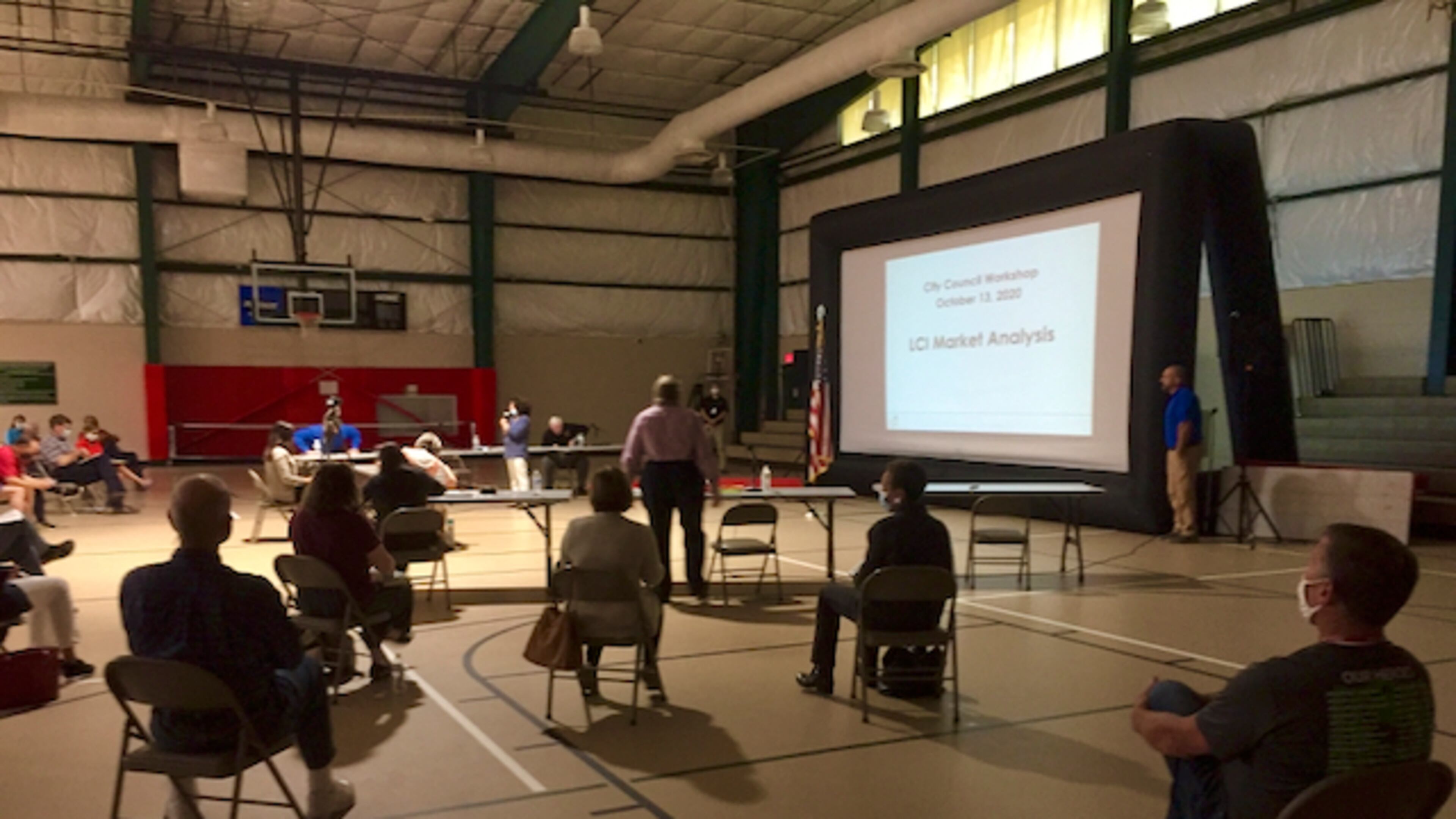 Peachtree City Mayor Vanessa Fleisch (center) addressed a socially distanced crowd on Oct. 13 to present findings from a market analysis of the city's economy. Jill Howard Church for the AJC