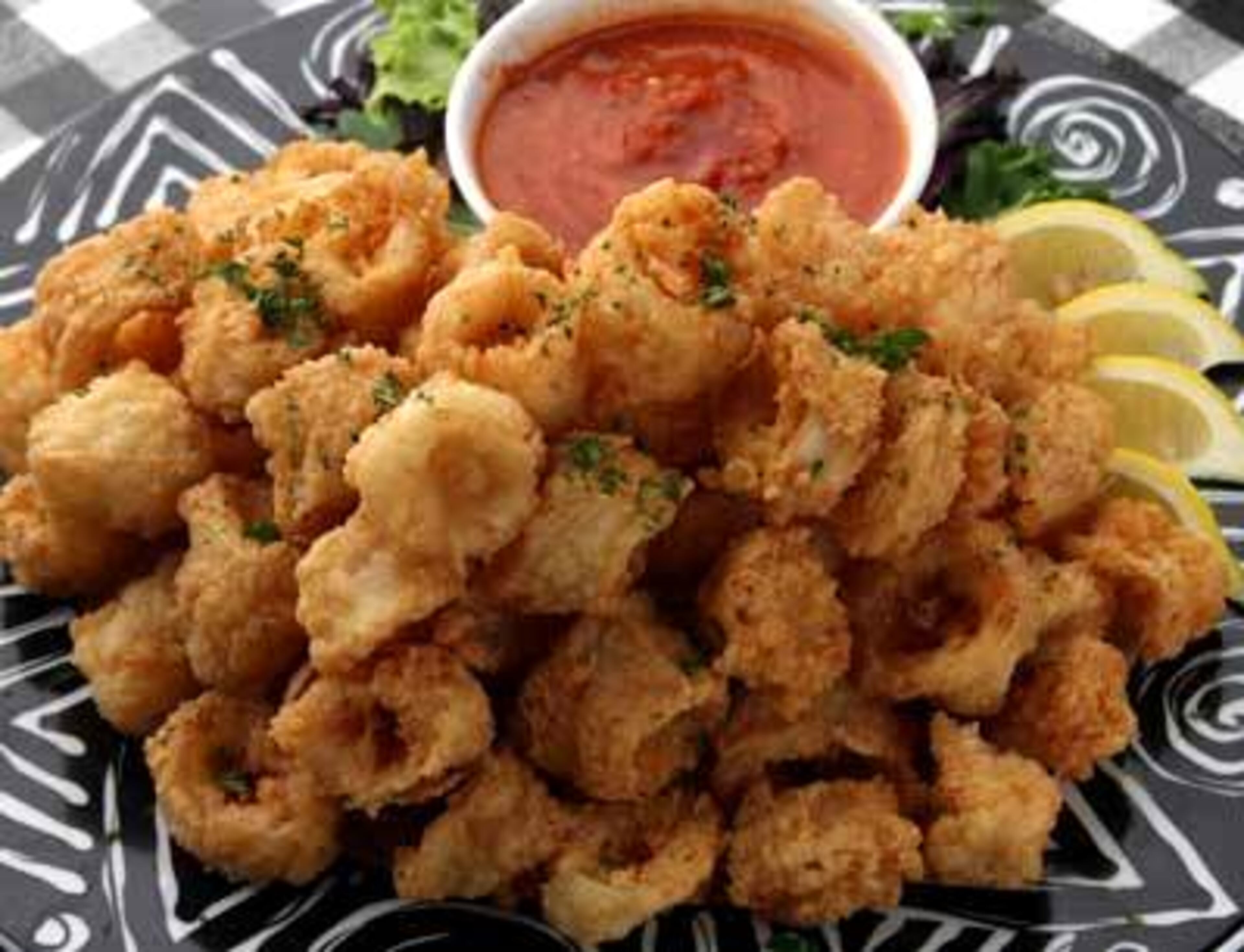SPLURGE: A yummy 6 ounces of fried calamari will set you back 400 calories and a whopping 16 grams of fat. That's before you even get to the entree!