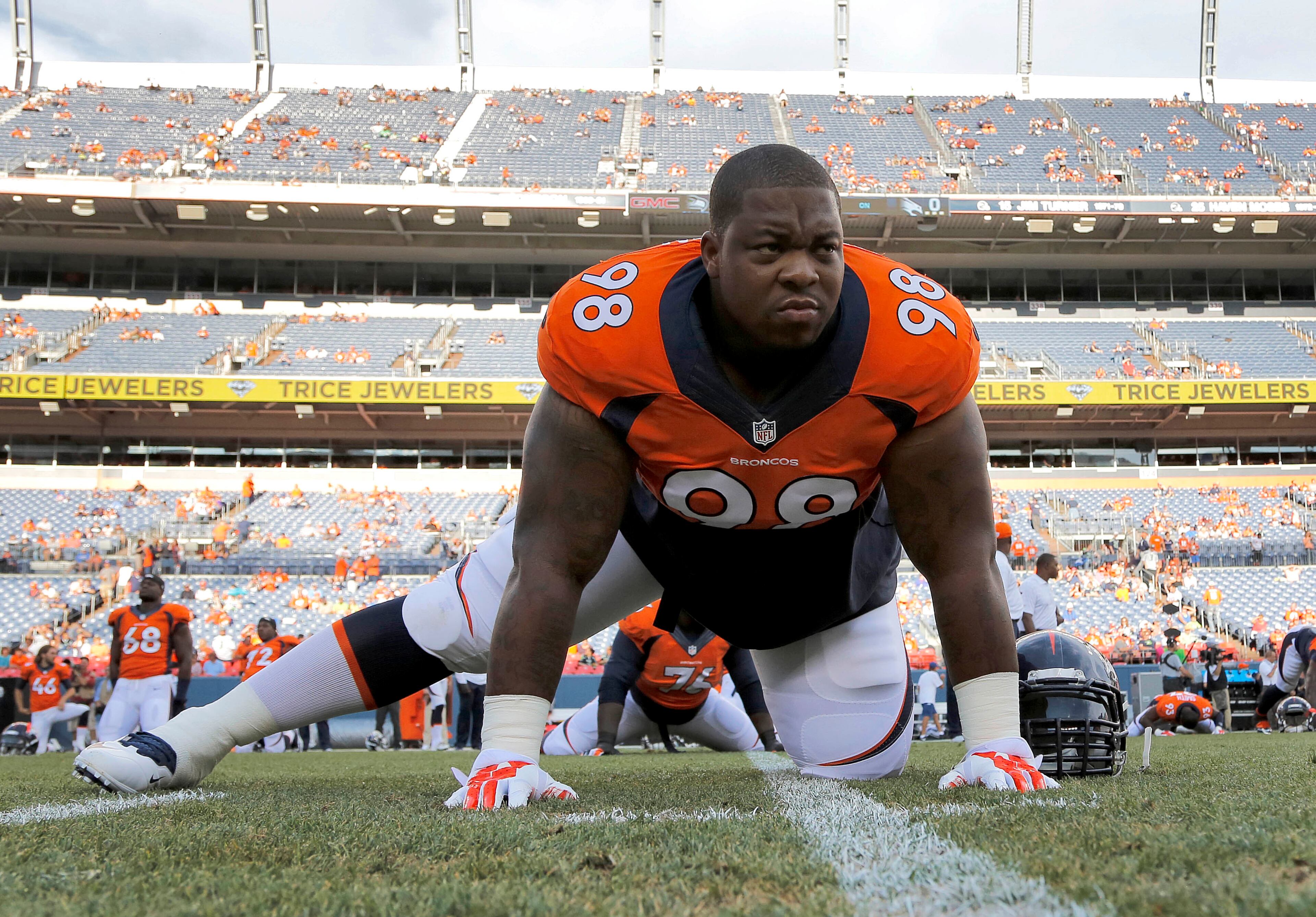 Denver Broncos defensive tackle Terrance Knighton stretches prior to an NFL preseason football game against the Seattle Seahawks, Thursday, Aug. 7, 2014, in Denver. (AP Photo/Jack Dempsey)