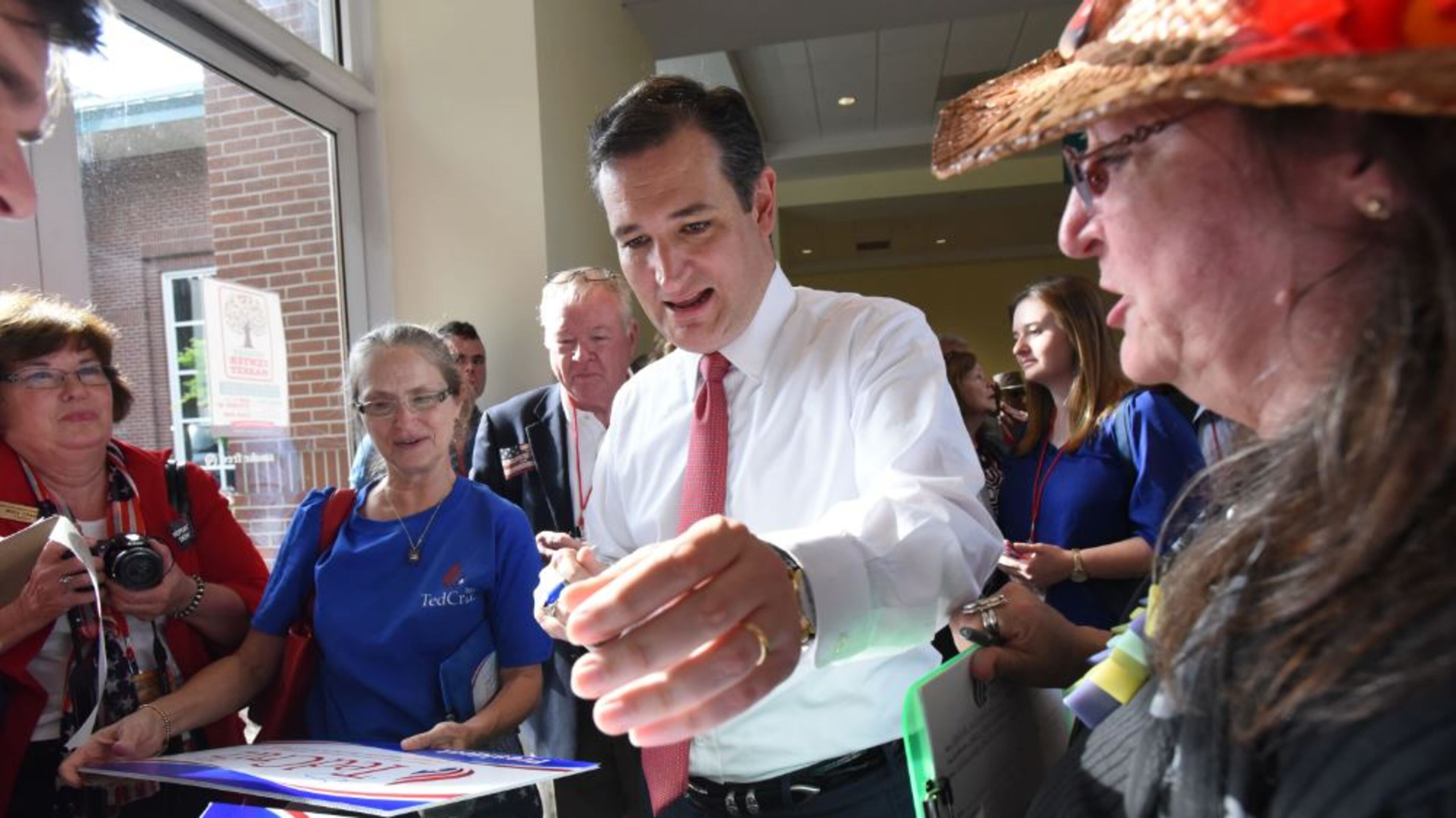 2016 GOP presidential candidate Ted Cruz autographs a sign for supporter Deb Marks (right) of Columbia, S.C., during the Georgia Republican Party State Convention in Athens in May. Hyosub Shin, hshin@ajc.com