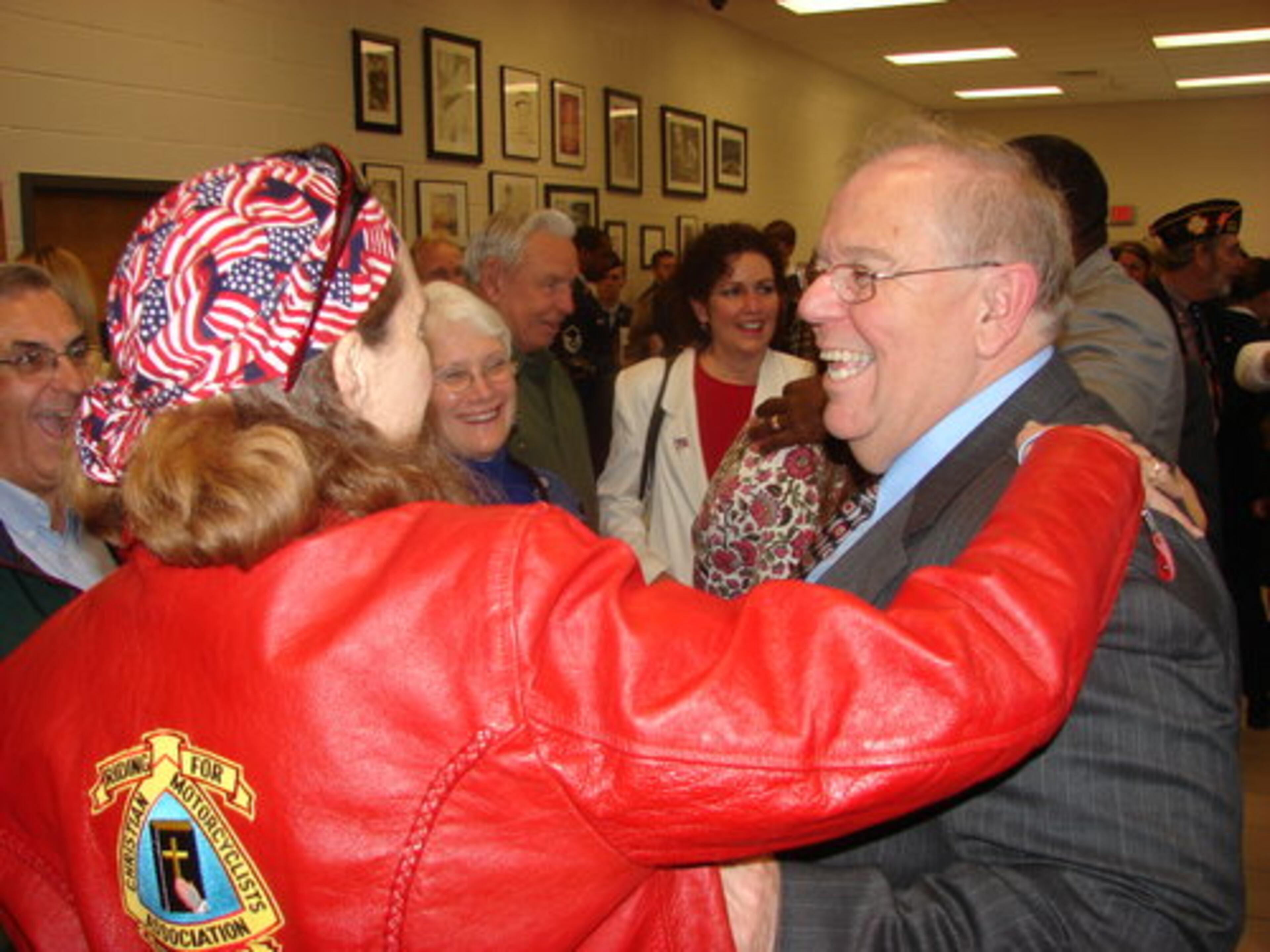 Bill Ayers greets a well-wisher after the Sunday ceremony. In July 2008, his son, Cpl. Jonathan Jonathan Ayers picked up an M-240 machine gun and unleashed a hail of bullets from the observation post of a small base American soldiers had set up only days before. A Taliban bullet grazed Ayers' helmet and knocked him back. But the 24-year-old soldier did not recoil. His paratrooper instincts took over.