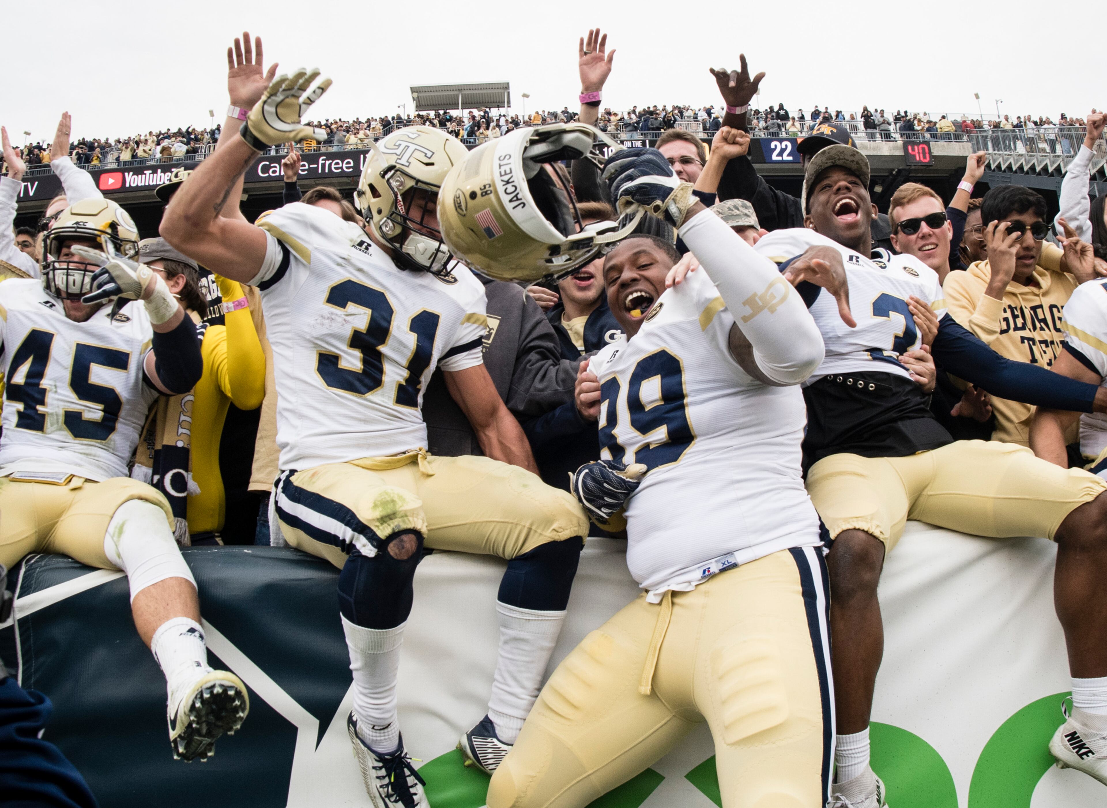 Georgia Tech defensive lineman Antwan Owens (89), running back Nathan Cottrell (31) and defensive back Tre Swilling (3) and linebacker T.D. Roof (45) celebrate after a football game against Virginia Tech on Saturday, Nov.11, 2017, in Atlanta. Georgia Tech won 28-22. (Photo/John Amis)