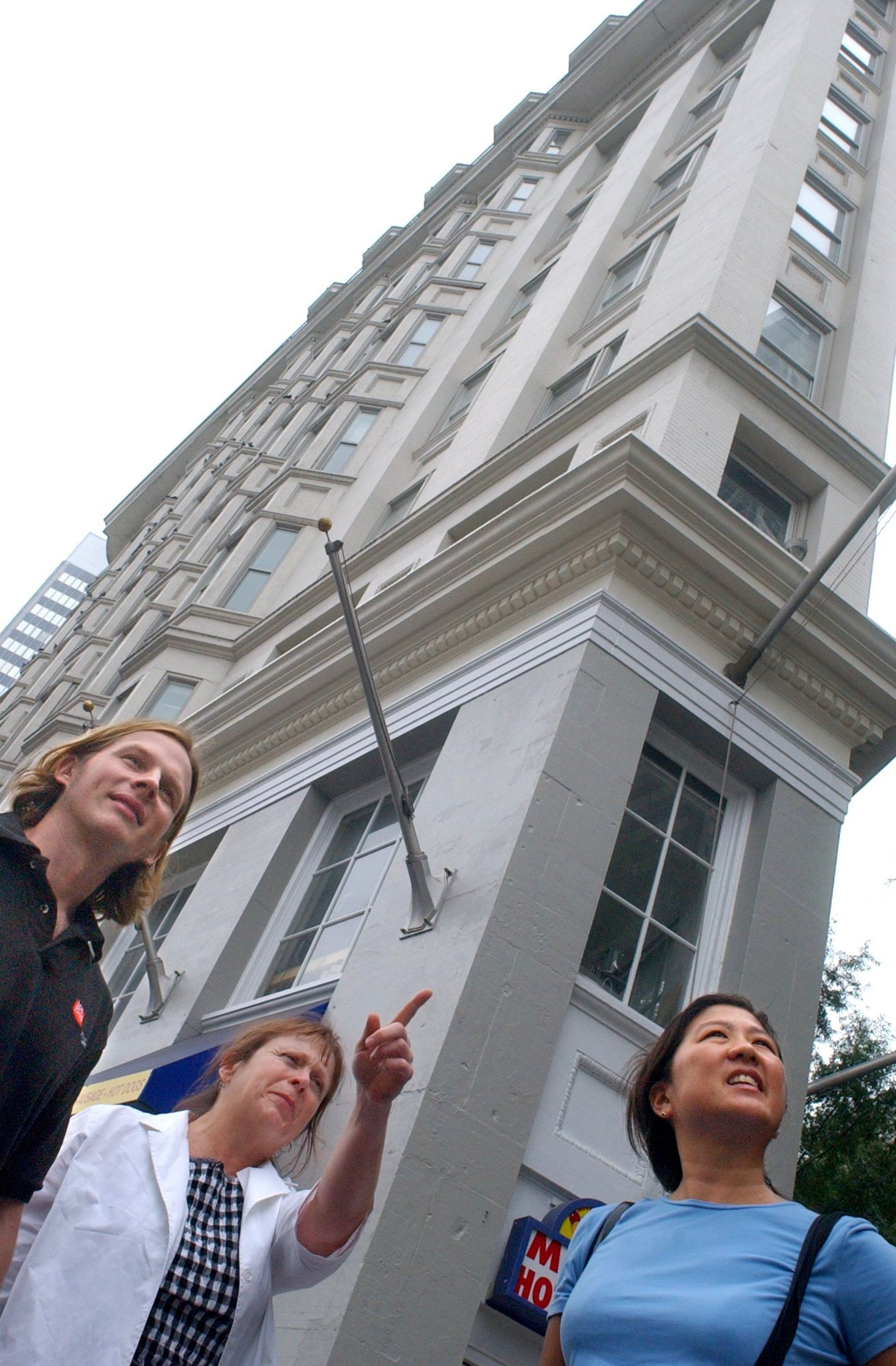 2008: Volunteer tour guides Brian Karpinski, Rebecca Roberts and Nancy Tao conduct a tour of Atlanta's historic buildings, including sthe Flatiron Building behind them, to commemorate 9/11.
