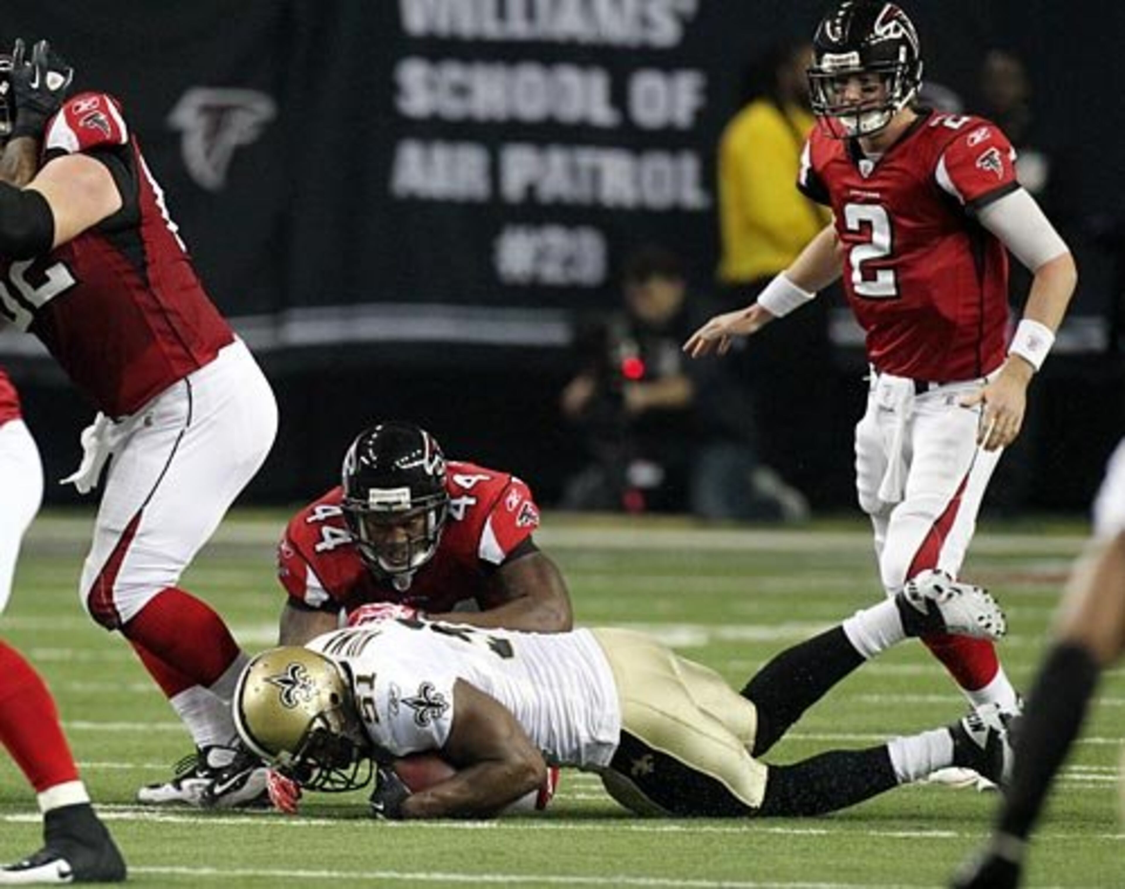 Falcons quarterback Matt Ryan looks on as the exchange is fumbled at the line and New Orleans Saints linebacker Jonathan Vilma recovers the fumble in front of Falcons running back Jason Snelling during 2nd quarter action at the Georgia Dome in Atlanta on Monday, Dec. 27, 2010. The Saints went on a touchdown drive to take a 10-0 lead after the recovery.