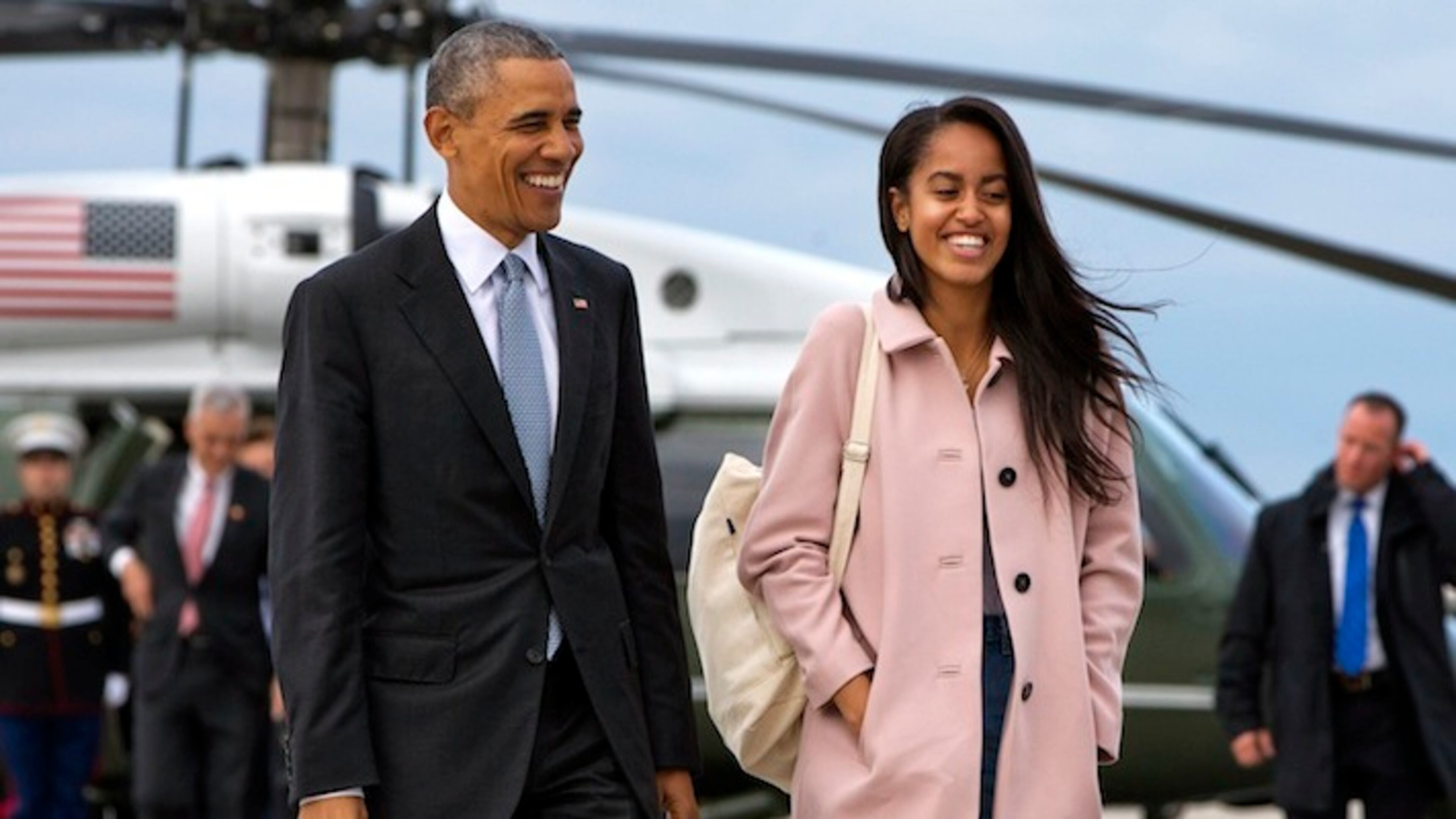 FILE - In a Thursday, April 7, 2016 file photo, President Barack Obama jokes with his daughter Malia Obama as they walk to board Air Force One from the Marine One helicopter, as they leave Chicago en route to Los Angeles. The White House announced Sunday, May 1, 2016, that Malia Obama will take a year off after high school and attend Harvard University in 2017. (AP Photo/Jacquelyn Martin, File)