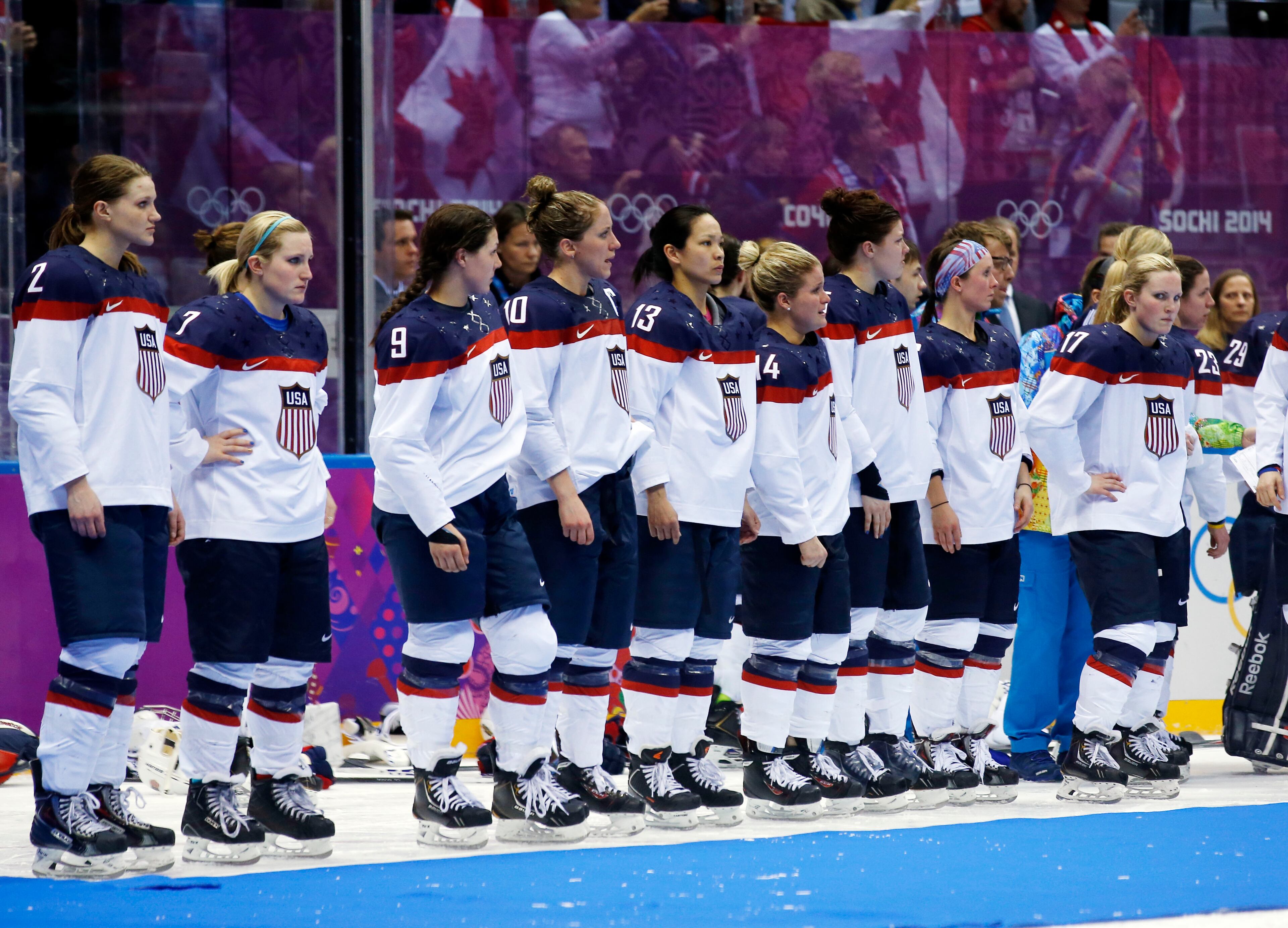 Team USA stands on the ice awaiting their silver medals after losing 3-2 to Canada in overtime of the women's gold medal ice hockey game at the 2014 Winter Olympics, Thursday, Feb. 20, 2014, in Sochi, Russia. (AP Photo/Matt Slocum)