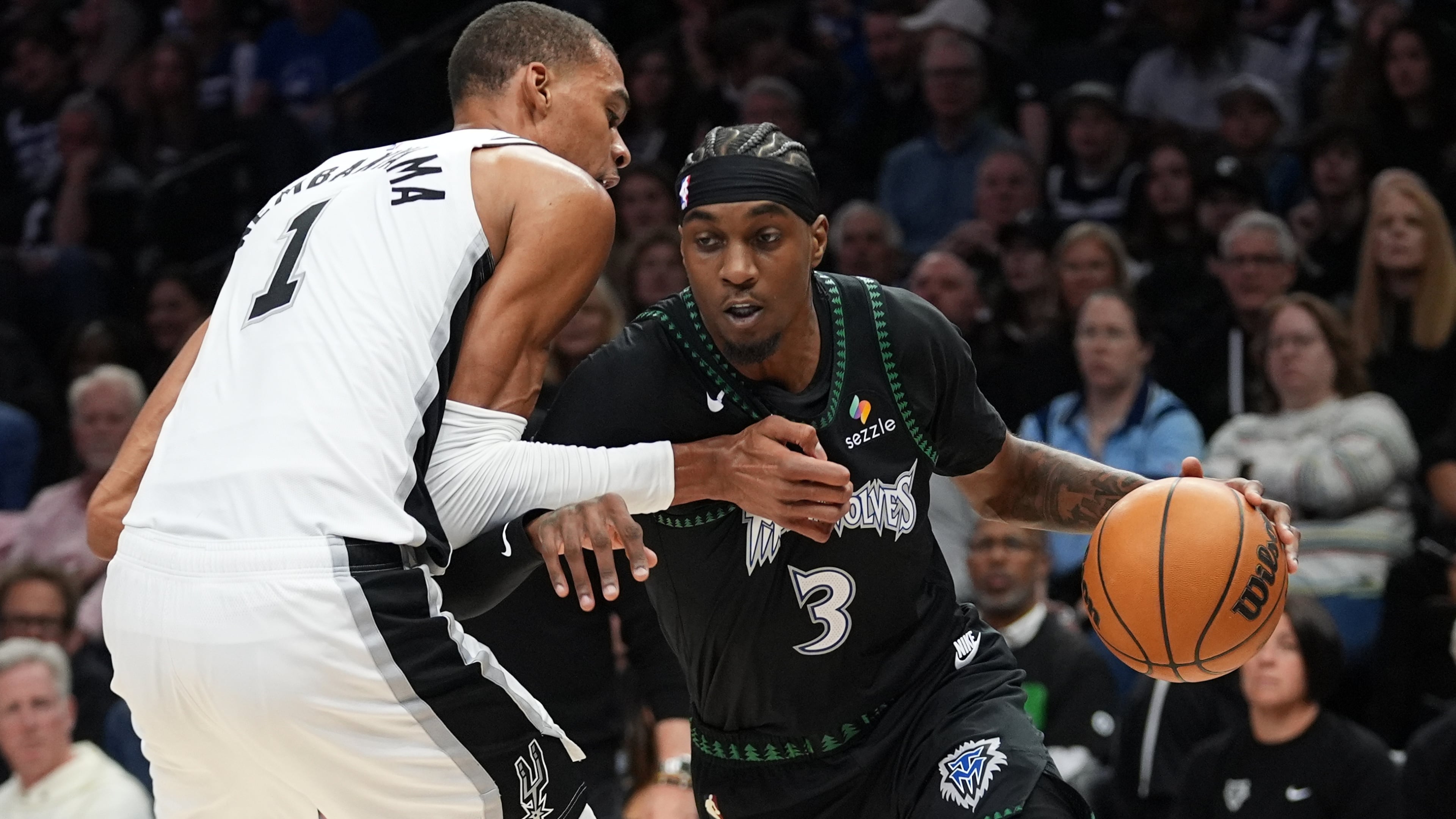 Minnesota Timberwolves forward Jaden McDaniels (3) drives against San Antonio Spurs forward Victor Wembanyama (1) during the first half of Game 3 of a NBA basketball second-round playoff series in Minneapolis, Friday, May 8, 2026. (AP Photo/Abbie Parr)