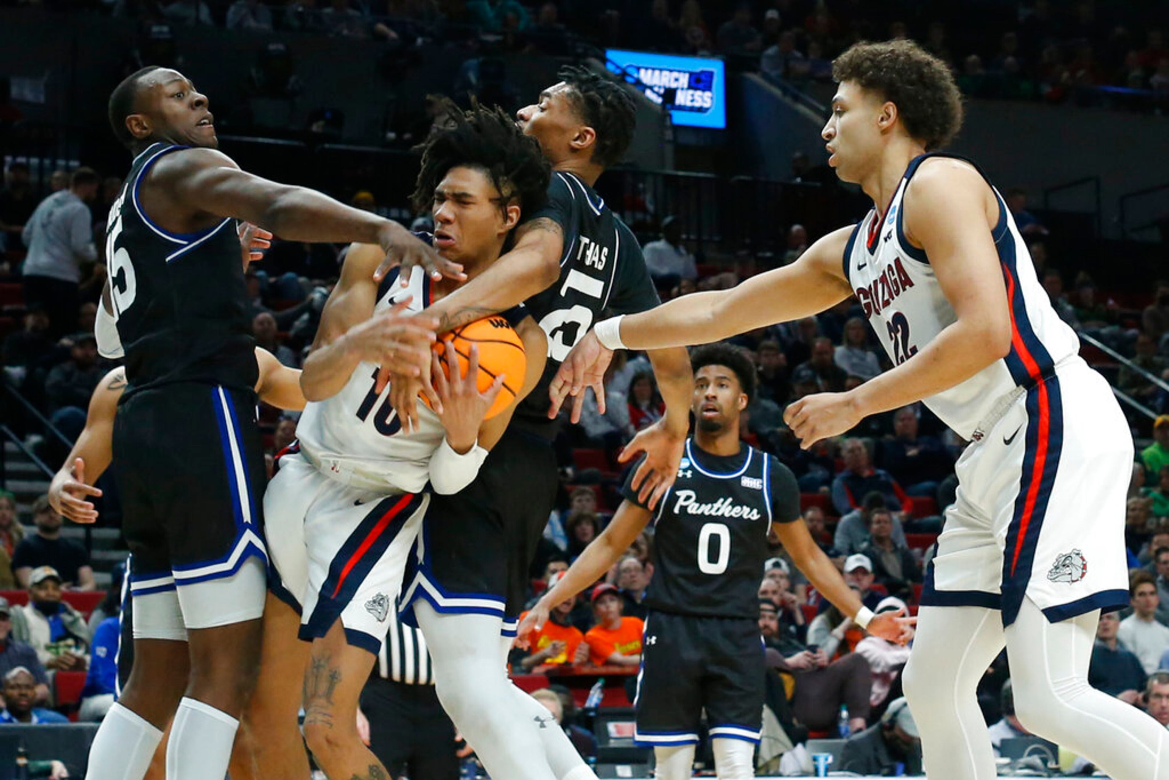 Gonzaga guard Hunter Sallis, second from left, is caught between Georgia State forward Ja'Heim Hudson, left, and forward Jalen Thomas, third from left, as Gonzaga forward Anton Watson, right, looks on during the first half of a first round NCAA college basketball tournament game, Thursday, March 17, 2022, in Portland, Ore. (AP Photo/Craig Mitchelldyer)