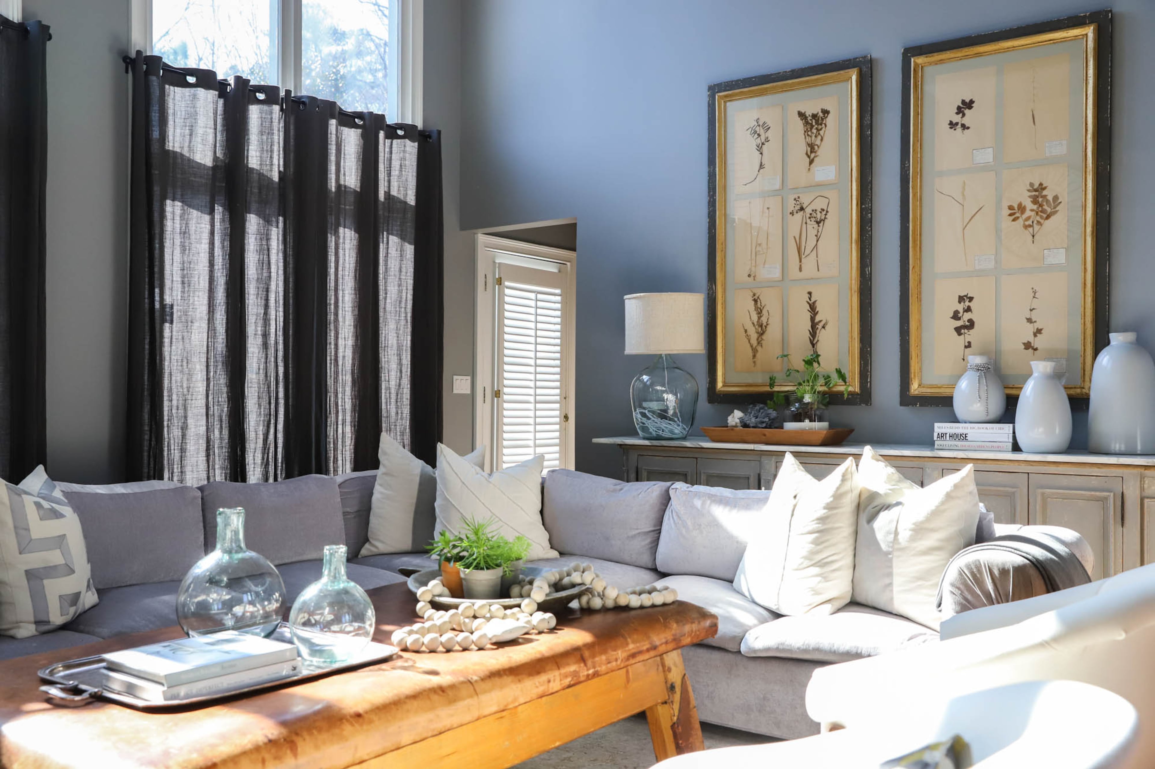 The great room of Joe and Stacy Borocz’s home is open and comfortable, with a wall of windows that gives the room a lot of natural light. A sectional sofa from Mason-Art creates a comfortable place for friends and family to gather, and an antique gymnasts’ bench from Munich, Germany, serves as a coffee table that can be cleared for extra seating. Text by Shannon Dominy/Photo by Reynolds Rogers