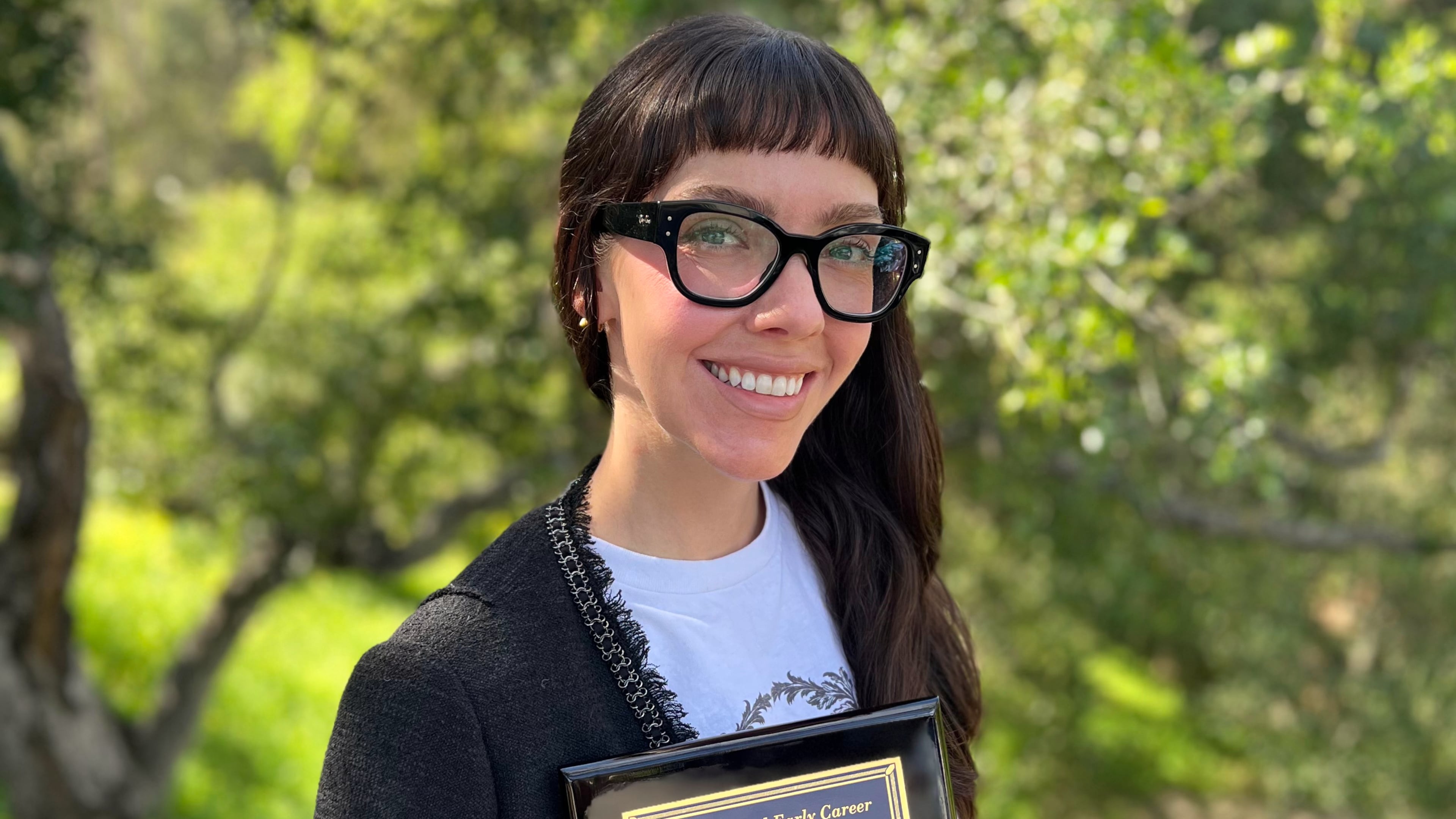 This photo taken with a smart phone and provided by Halley Froehlich shows Froehlich holding a U.S. Aquaculture Society award in Santa Barbara, Calif., on Feb. 27, 2026. (Halley Froehlich via AP)