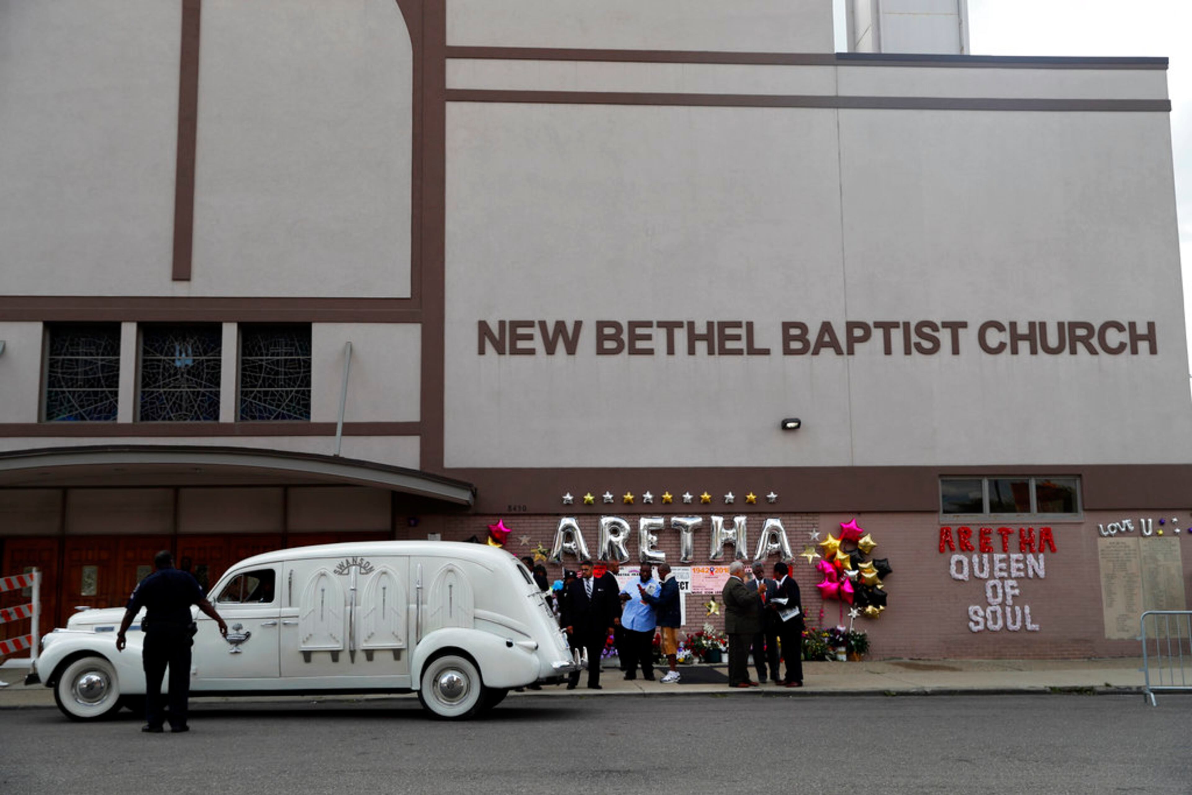 A hearse containing the casket of Aretha Franklin pulls up outside New Bethel Baptist Church Thursday, Aug. 30, 2018, in Detroit. Franklin died Aug. 16, 2018 of pancreatic cancer at the age of 76. (AP Photo/Jeff Roberson)
