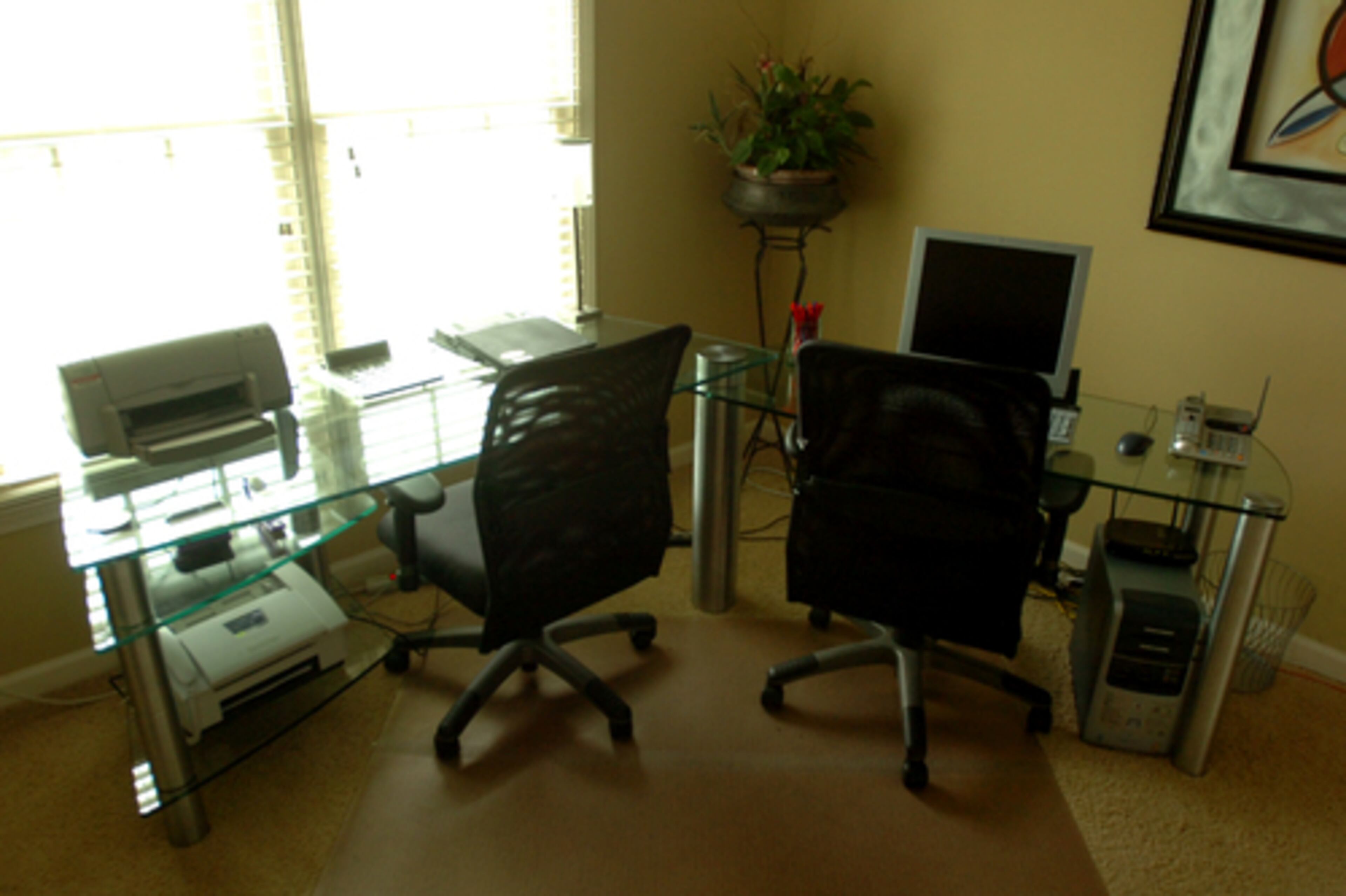 Pam Spencer's own office sports two contemporary, glass top desks. Spencer uses one for her pharmaceutical job, the other for her interior design business. "With double desks, I can utilize space efficiently and work on two things at the same time," she says.