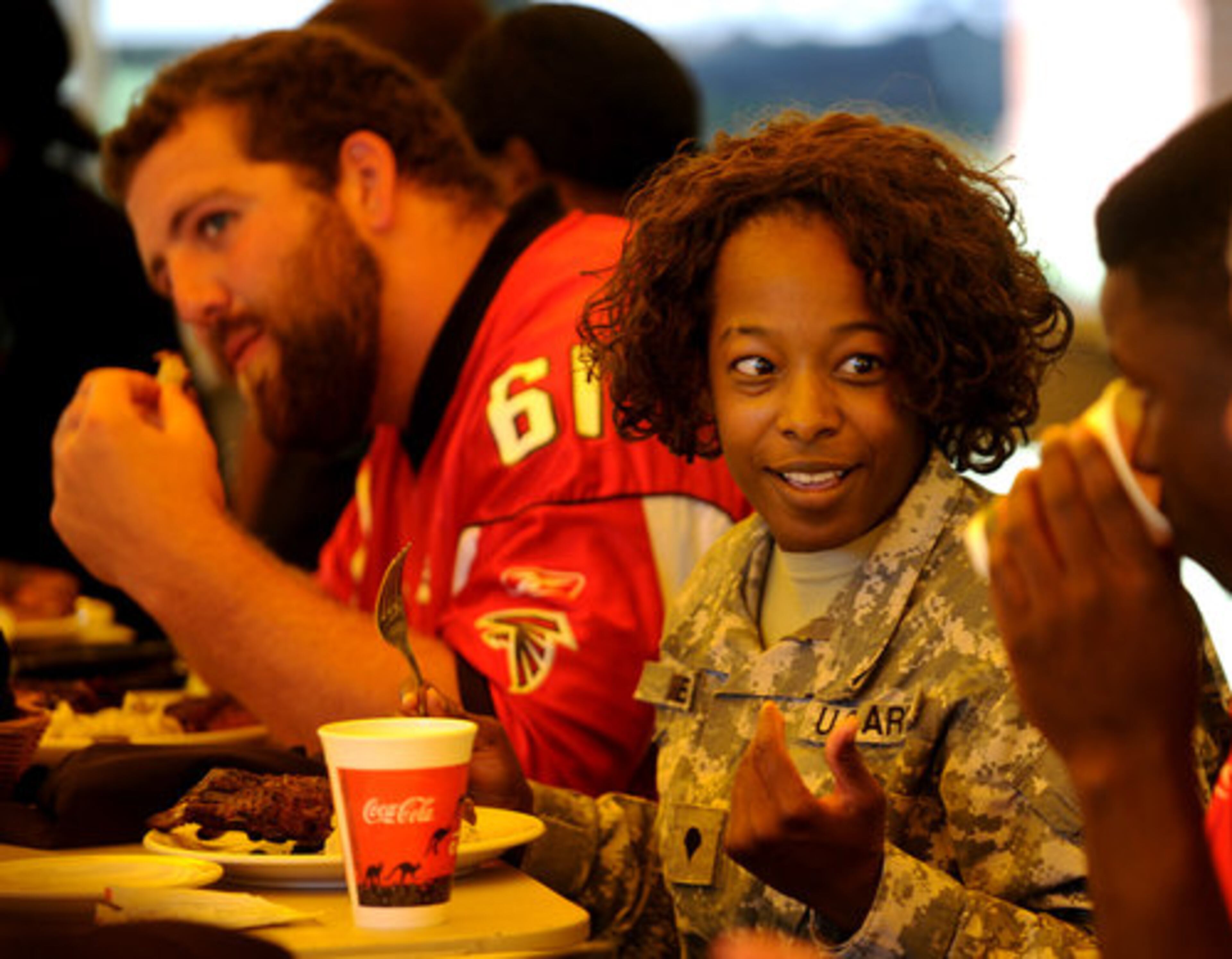Specialist Clare Daniels smiles as she talks to Atlanta Falcons Rookie Sean Weatherspoon during a lunch sponsored by Outback Steakhouse at Ft. McPherson on Tuesday, Sept 14,2010.