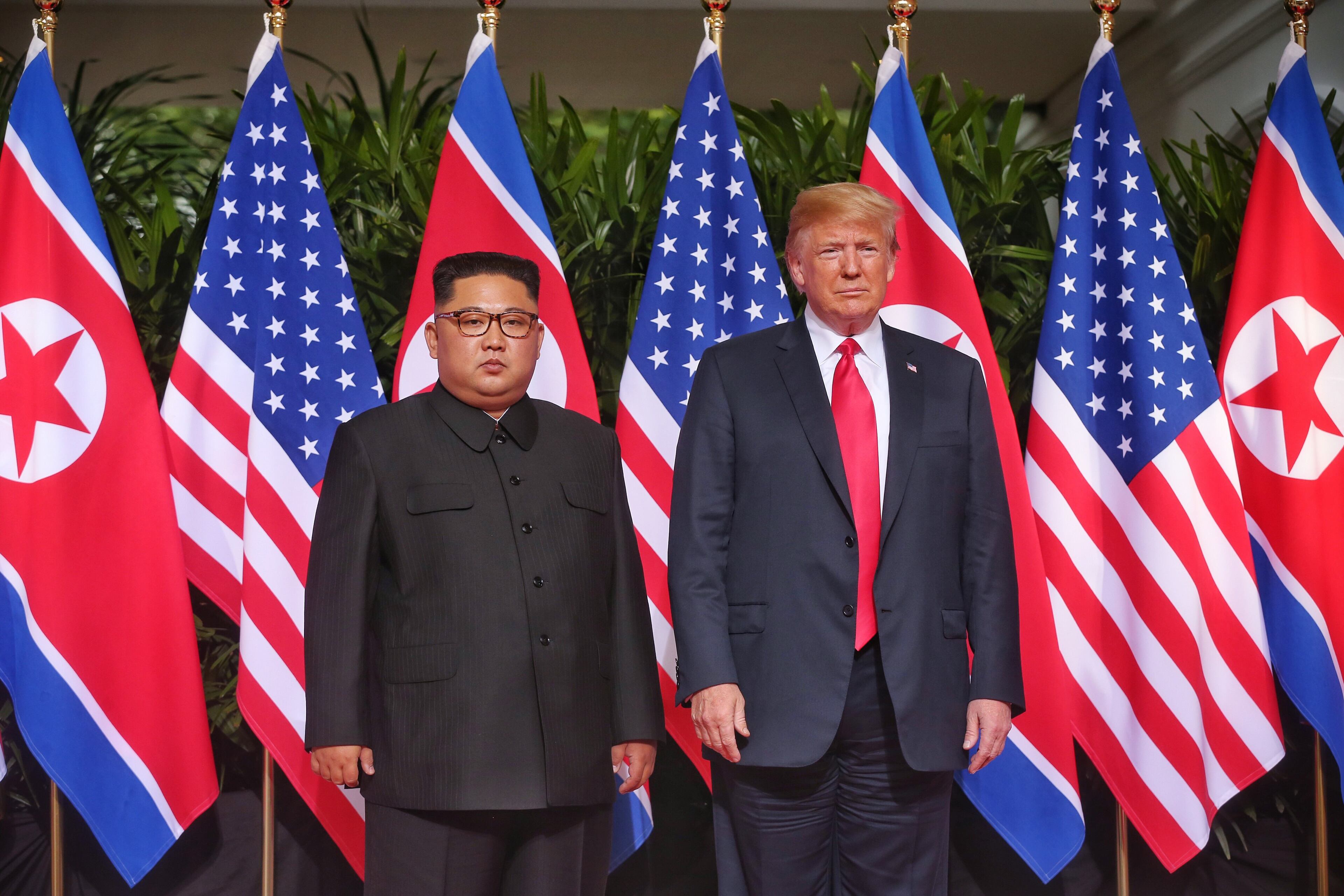SINGAPORE - JUNE 12: In this handout photo, North Korean leader Kim Jong-un (L) meets U.S. President Donald Trump during their historic U.S.-DPRK summit at the Capella Hotel on Sentosa island on June 12, 2018 in Singapore. U.S. President Trump and North Korean leader Kim Jong-un held the historic meeting between leaders of both countries on Tuesday morning in Singapore, carrying hopes to end decades of hostility and the threat of North Korea's nuclear program. (Photo by Kevin Lim/THE STRAITS TIMES/Handout/Getty Images)