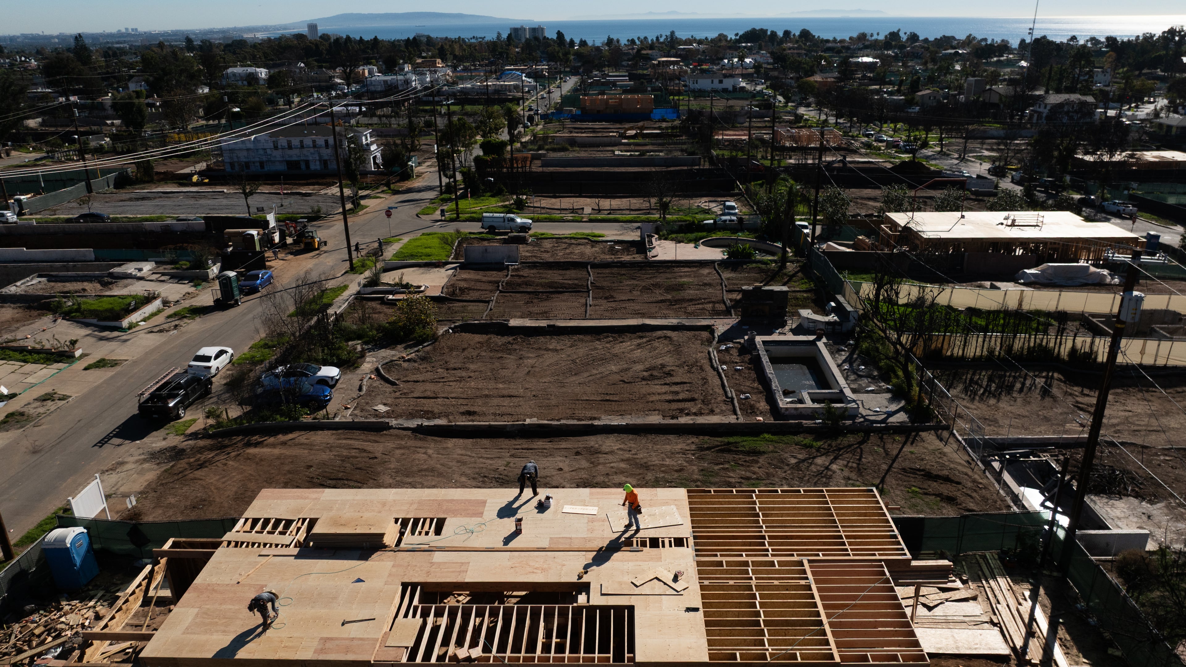 An aerial view shows houses being rebuilt on cleared lots months after the Palisades Fire, Dec. 5, 2025, in the Pacific Palisades neighborhood of Los Angeles. (AP Photo/Jae C. Hong)