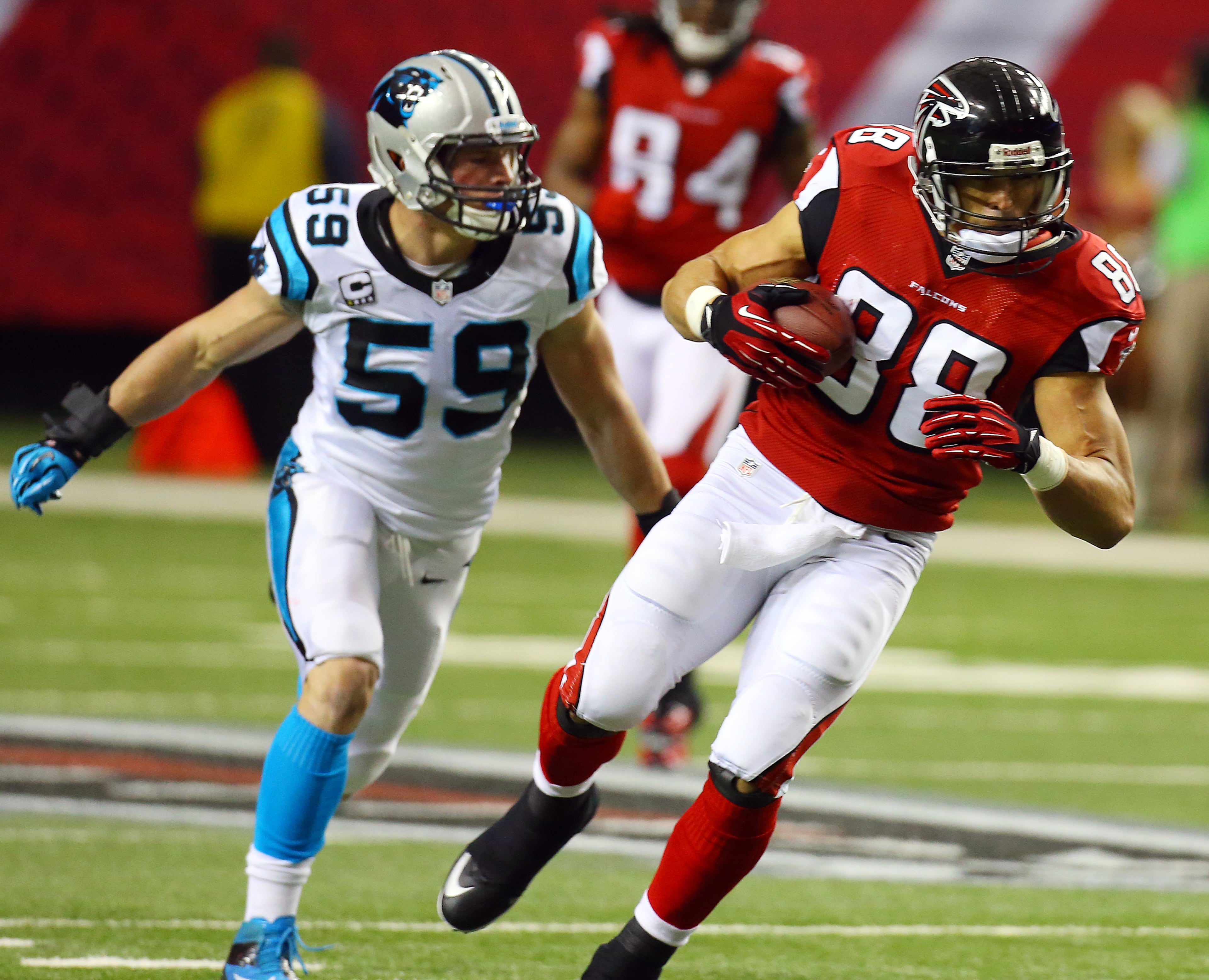 Falcons tight end Tony Gonzalez, playing in his final game of a 17-year NFL career, gets past Panthers linebacker Luke Kuechly for a first down catch during the first half of their NFL football game on Sunday, Dec. 29, 2013, in Atlanta.