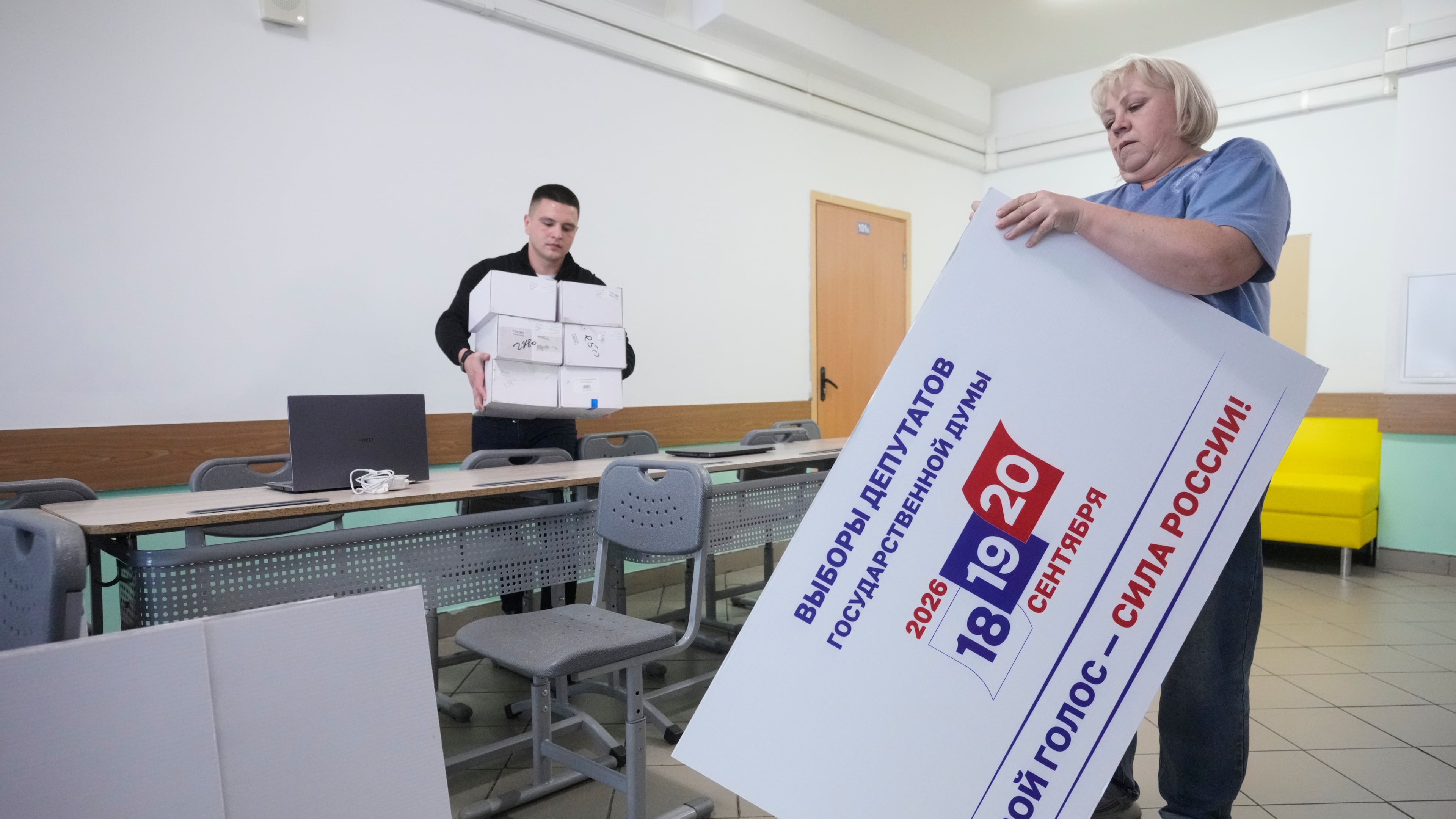 Precinct election commission members set up a polling station for the upcoming parliamentary elections in Moscow, on Thursday, Sept. 17, 2026. (AP Photo/Pavel Bednyakov)