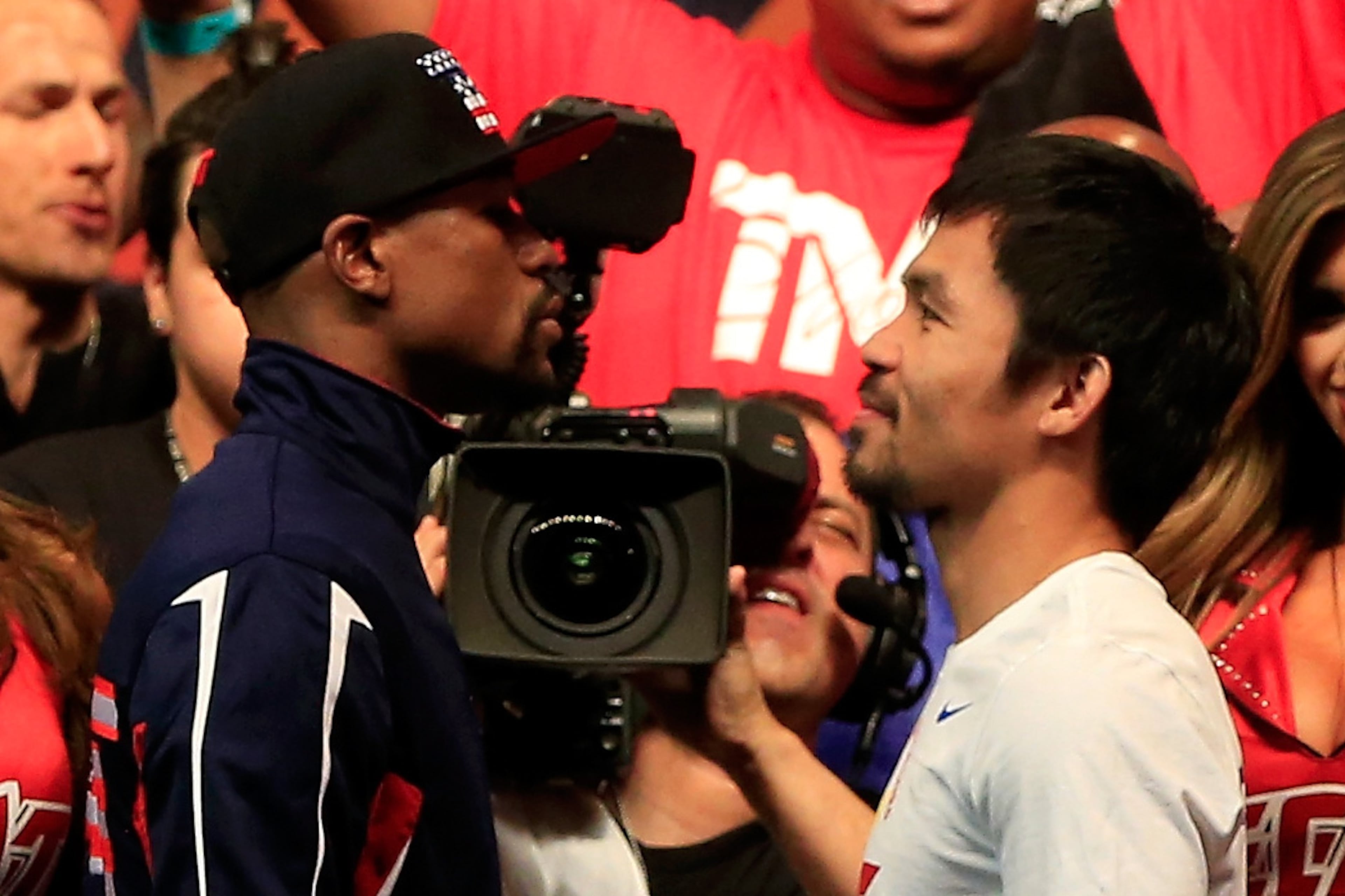 LAS VEGAS, NV - MAY 01: Floyd Mayweather Jr. (L) and Manny Pacquiao face off during their official weigh-in on May 1, 2015 at MGM Grand Garden Arena in Las Vegas, Nevada. The two will face each other in a welterweight unification bout on May 2, 2015 in Las Vegas. (Photo by Jamie Squire/Getty Images)