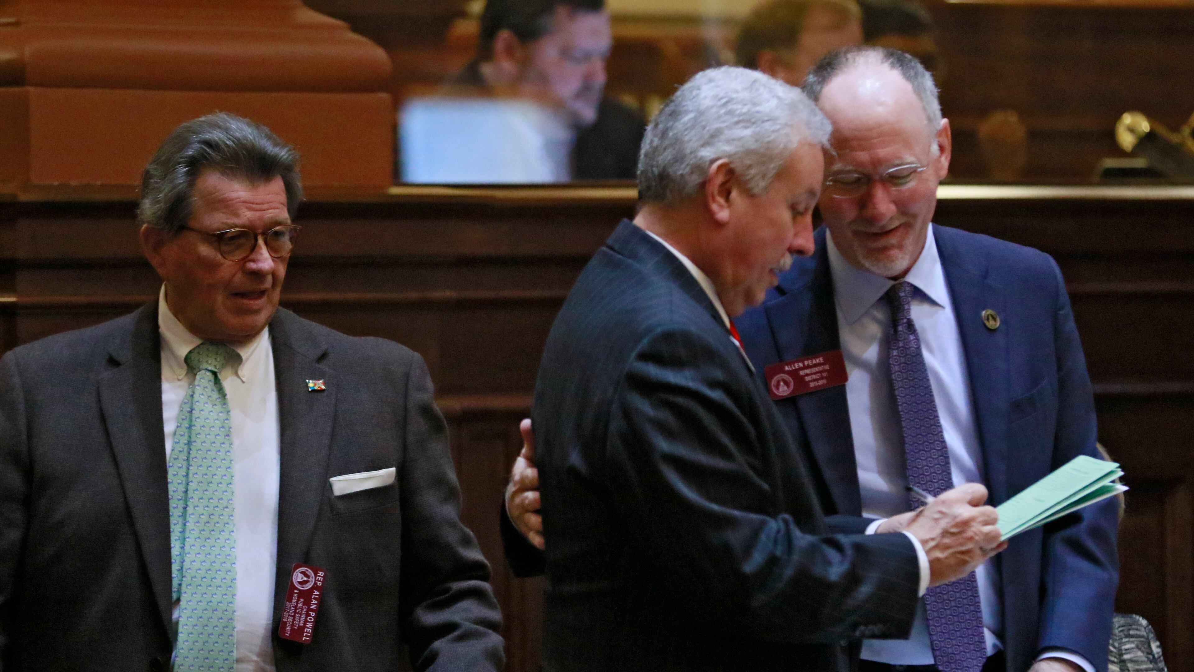 State Rep. Allen Peake, R – Macon, (right) gathers signatures for medical marijuana legislation he is proposing from Rep. Ron Stephens, R - Savannah. At left is Rep. Alan Powell. Bob Andres, bandres@ajc.com
