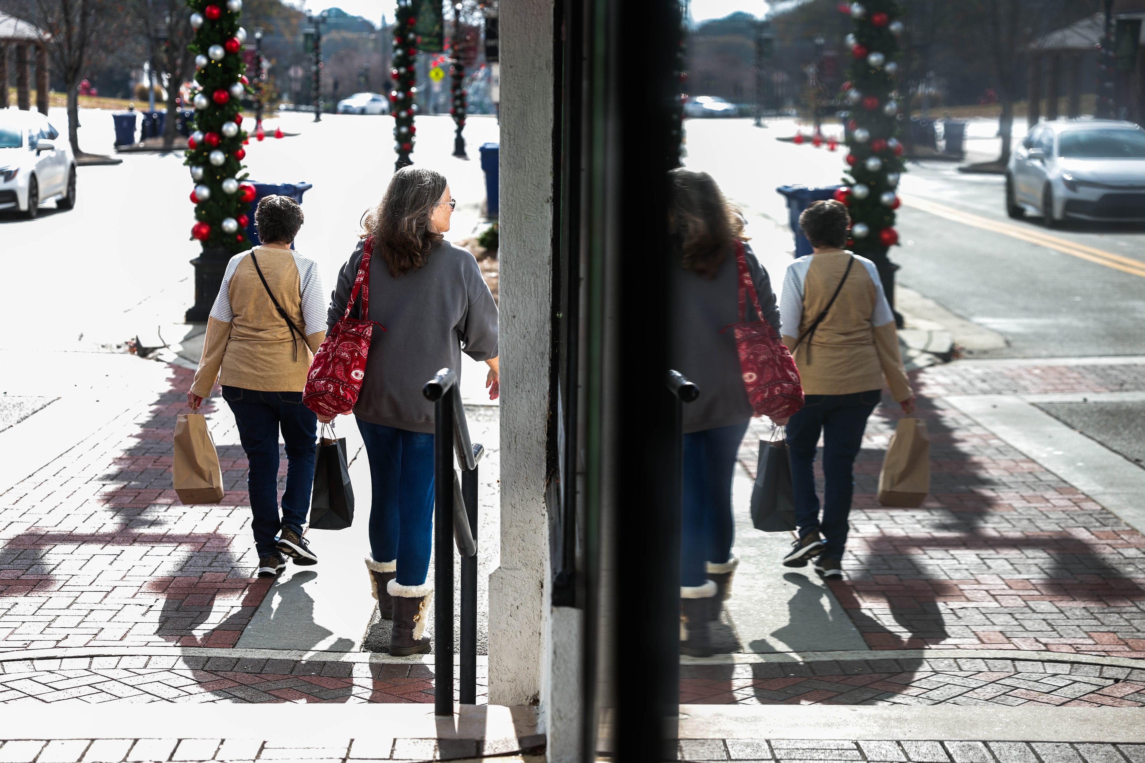 Women walk by with shopping bags in Dallas, Ga., on Saturday, November 22, 2025. Marjorie Taylor Greene announced she is resigning from Congress, Dallas is a town in her district. (Abbey Cutrer / AJC)