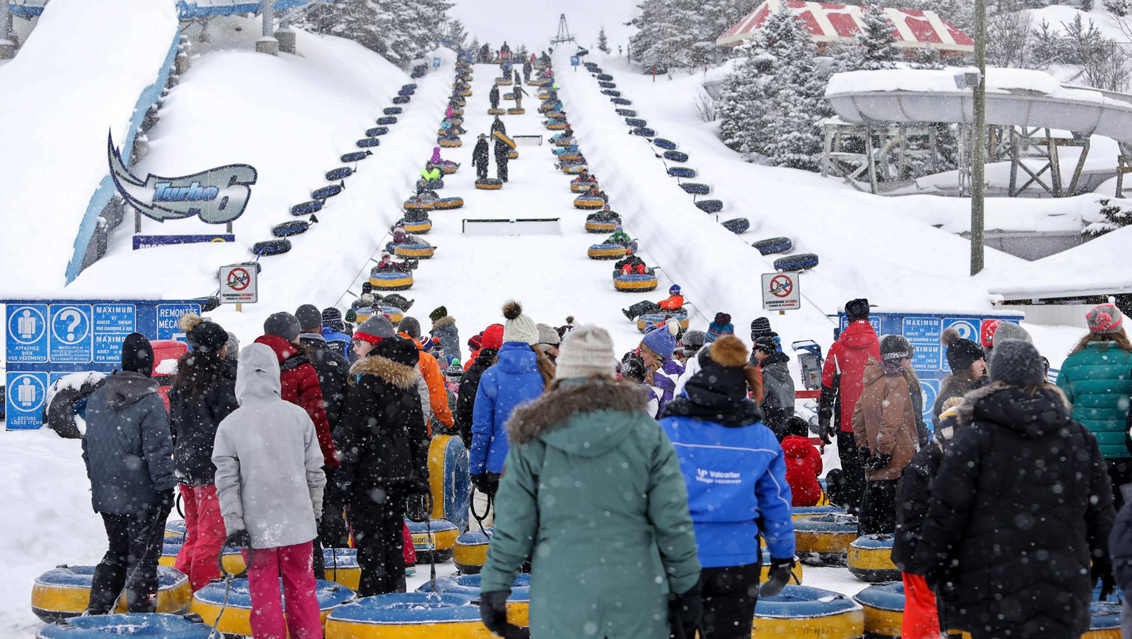 Visitors to Valcartier Winter Park wait to ride the inner tube lift. Just plop down and belts will take you to the top. (Brian Sirimaturos/St. Louis Post-Dispatch/TNS)