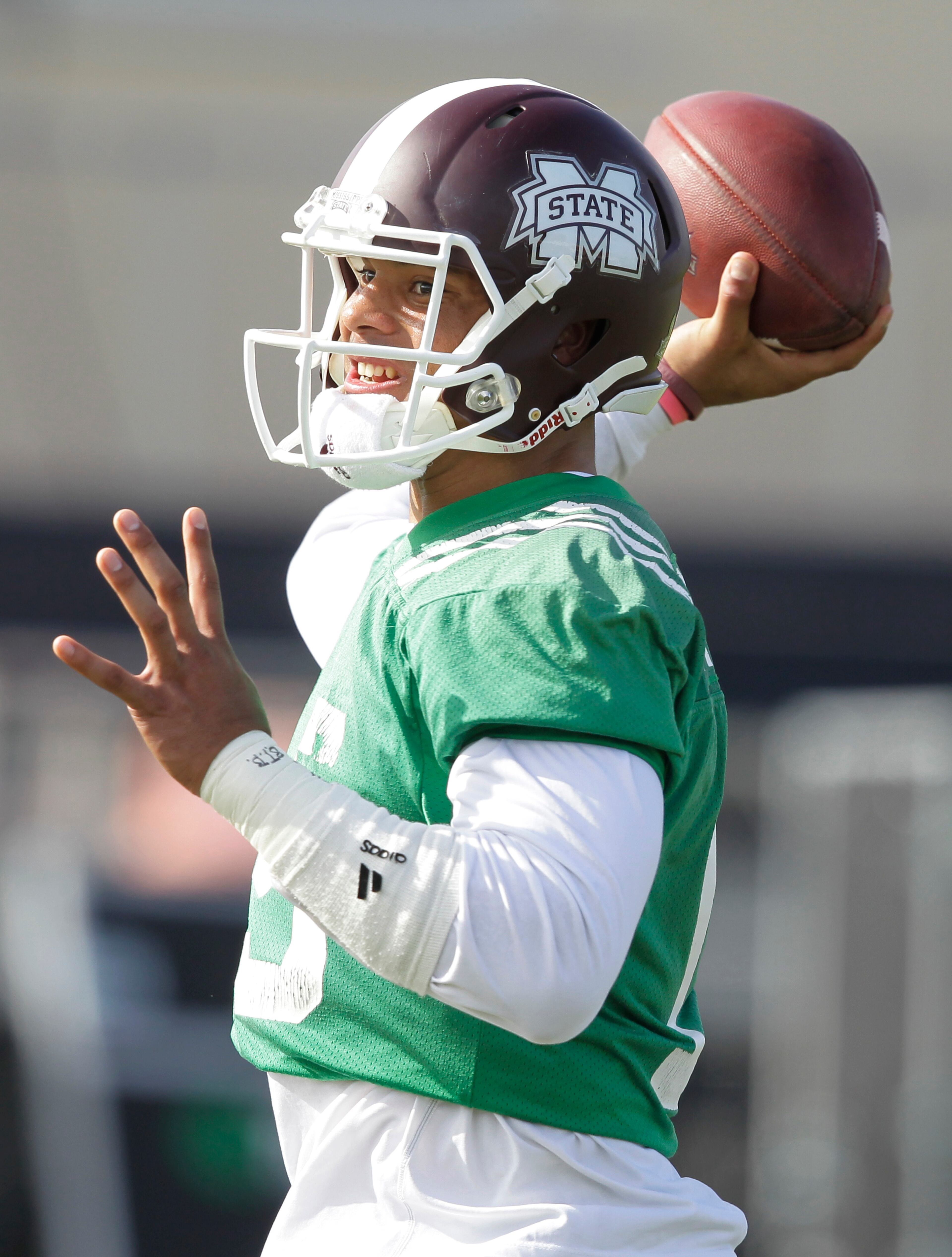 Mississippi State quarterback Dak Prescott (15) throws during practice at Barry University, Monday, Dec. 29, 2014 in Miami Shores, Fla. Mississippi State will face Georgia Tech in the Orange Bowl NCAA college football game on New Year's Eve. (AP Photo/Marta Lavandier)
