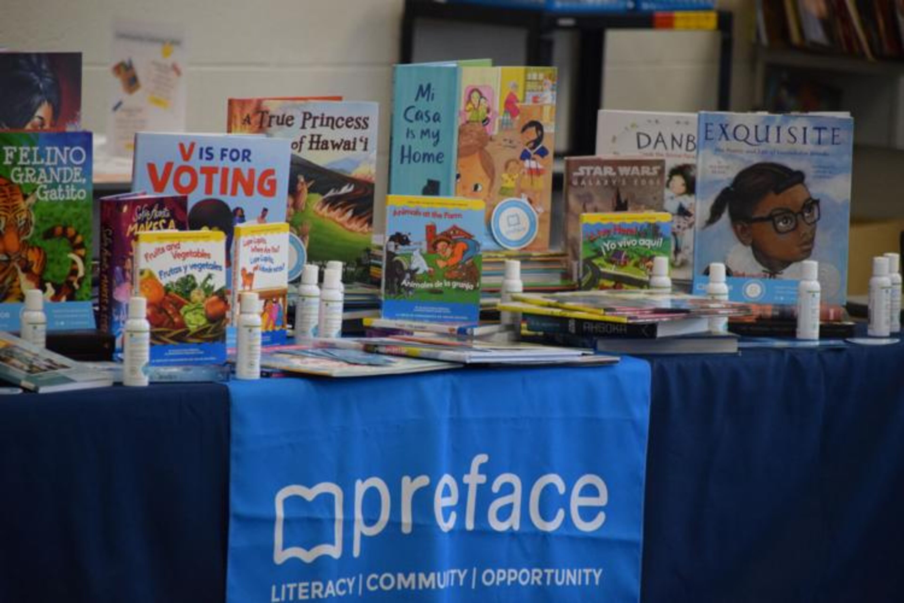 Some of the multilingual books that literacy education nonprofit, Preface, donated to Graves Elementary School's library sit on a table during a presentation ceremony at the school. (Courtesy of Curt Yeomans)