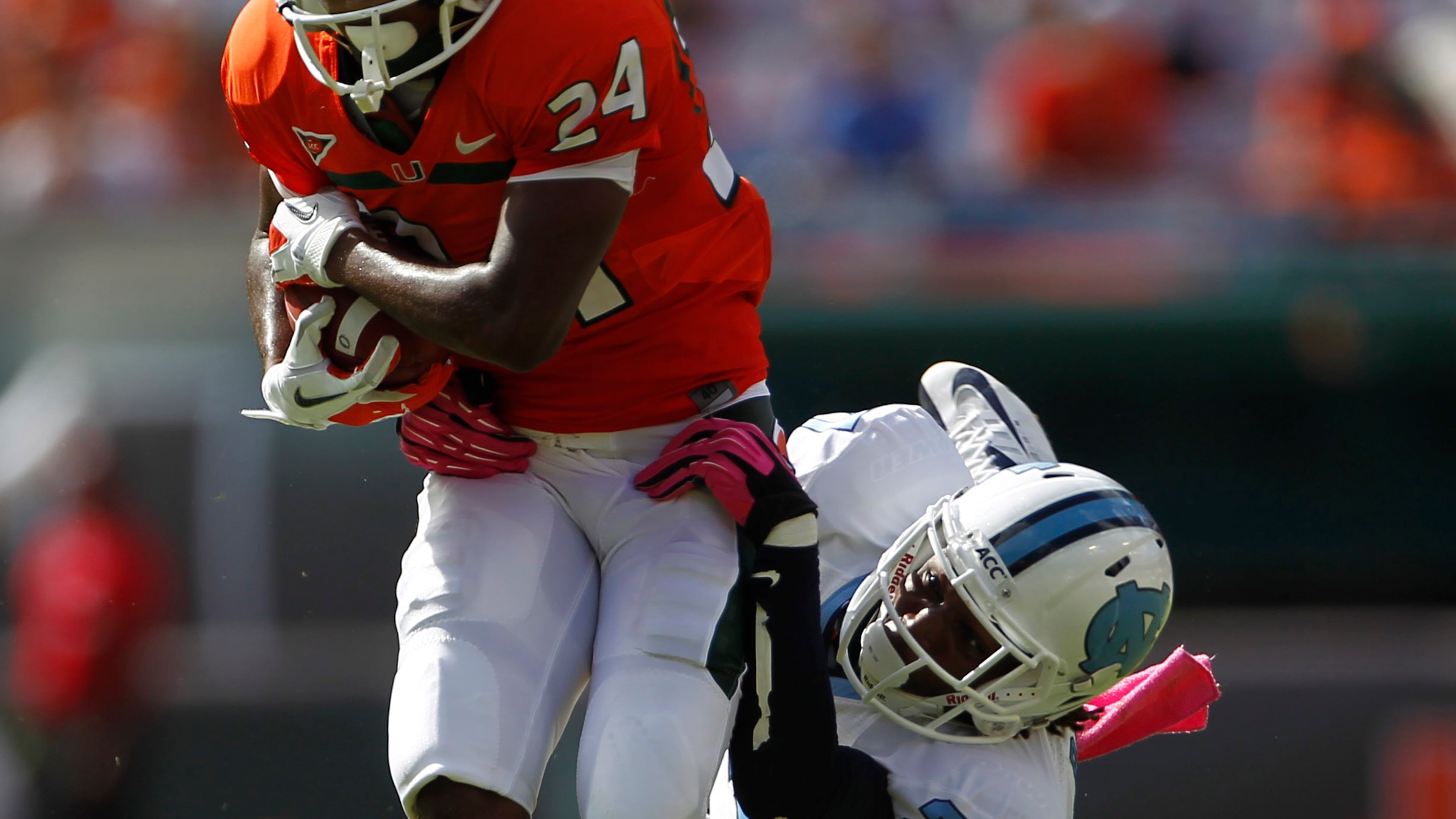 North Carolina's Darien Rankin (27) tackles Miami's Davon Johnson (24) during the first half of a NCAA college football game in Miami, Saturday, Oct. 13, 2012. (AP Photo/J Pat Carter)