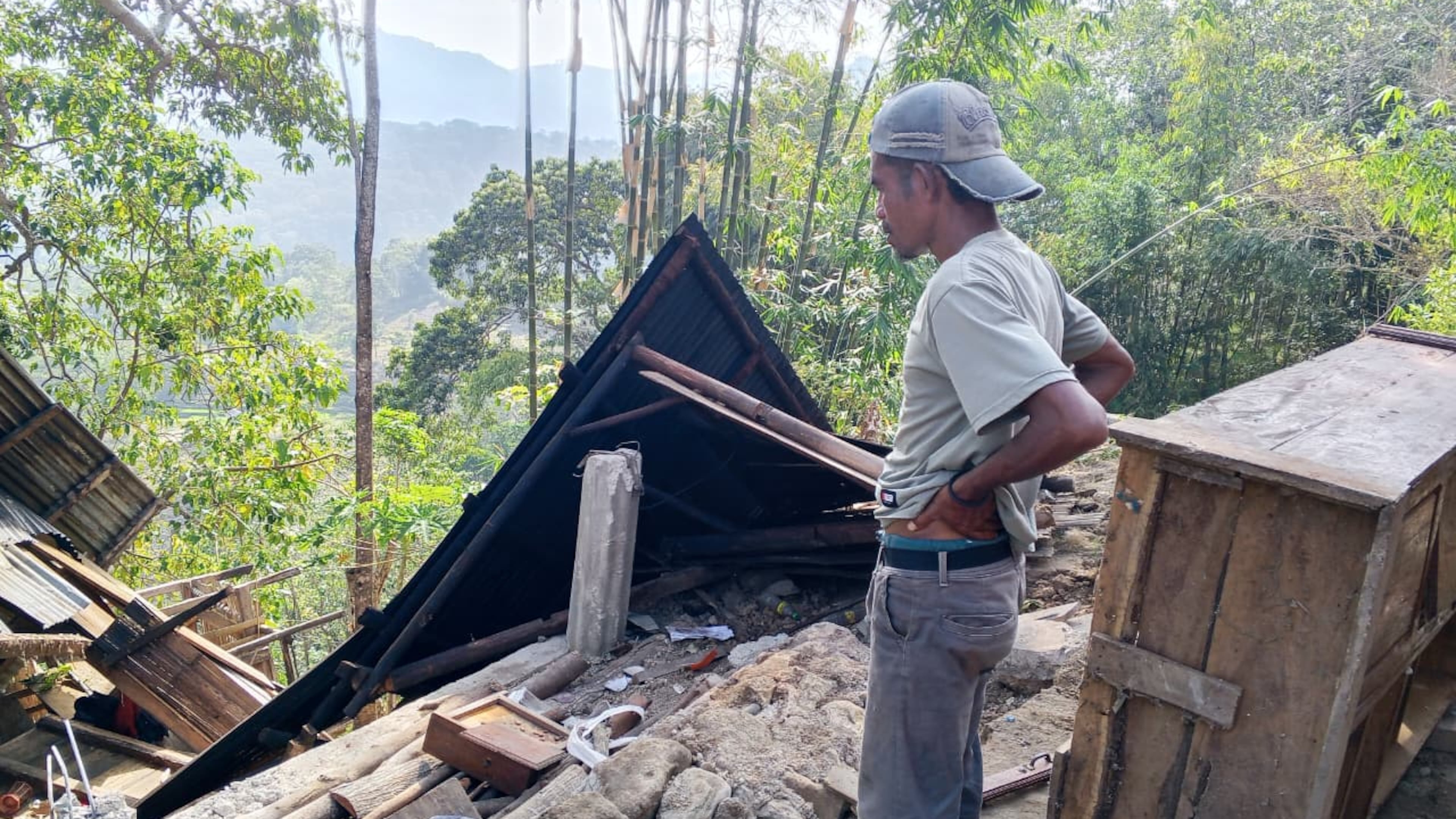 A man examines the damage to a building following an earthquake in East Manggarai, East Nusa Tenggara province, Indonesia, Saturday, Aug. 15, 2026. (AP Photo/Kurniawan)