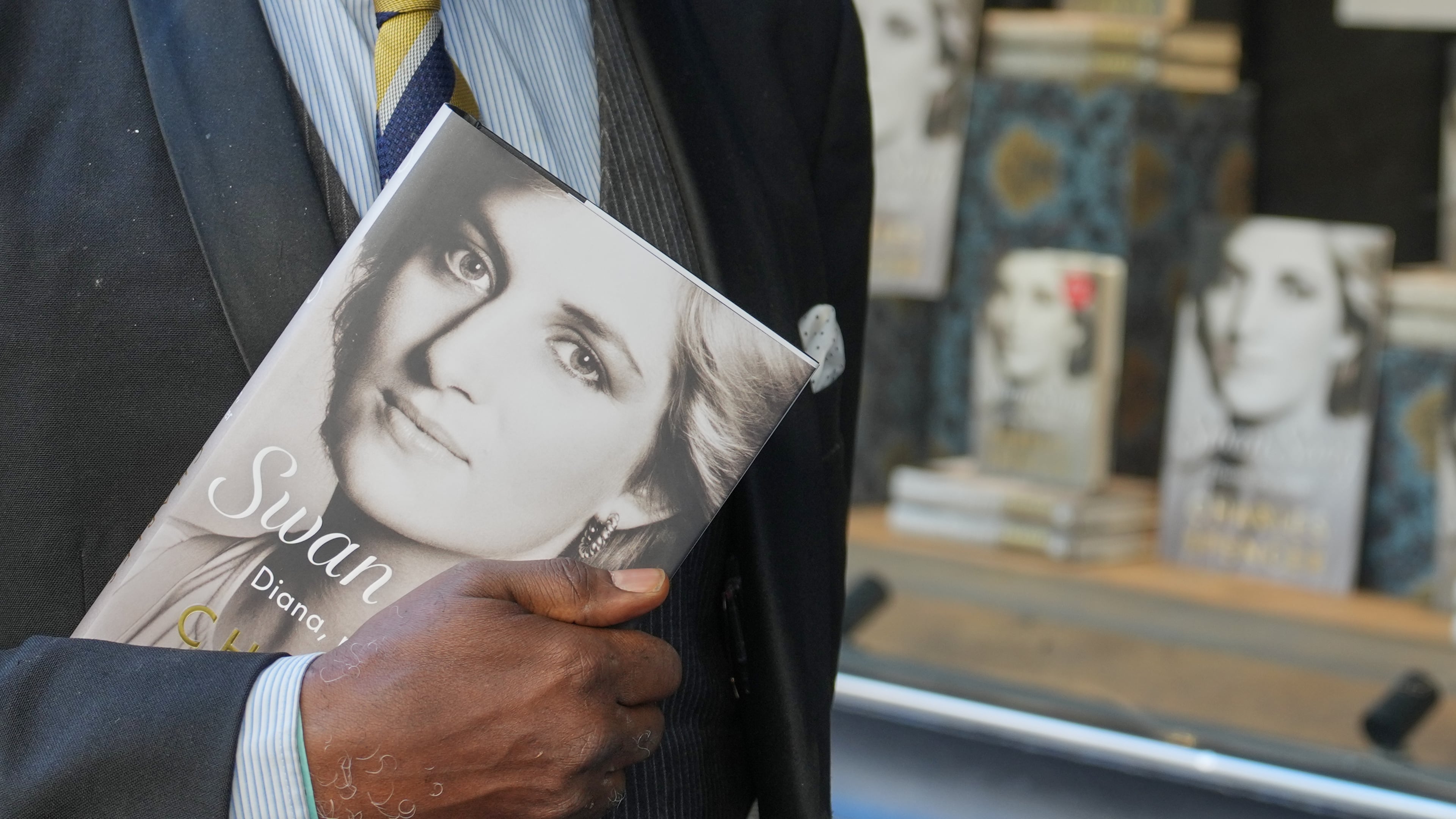 A man holds a copy of the new book by Earl Spencer, brother of the late Princess Diana, entitled "Swan Song: Diana, My Sister," outside a bookshop in central London, Tuesday, Sept. 22, 2026. (AP Photo/Kin Cheung)