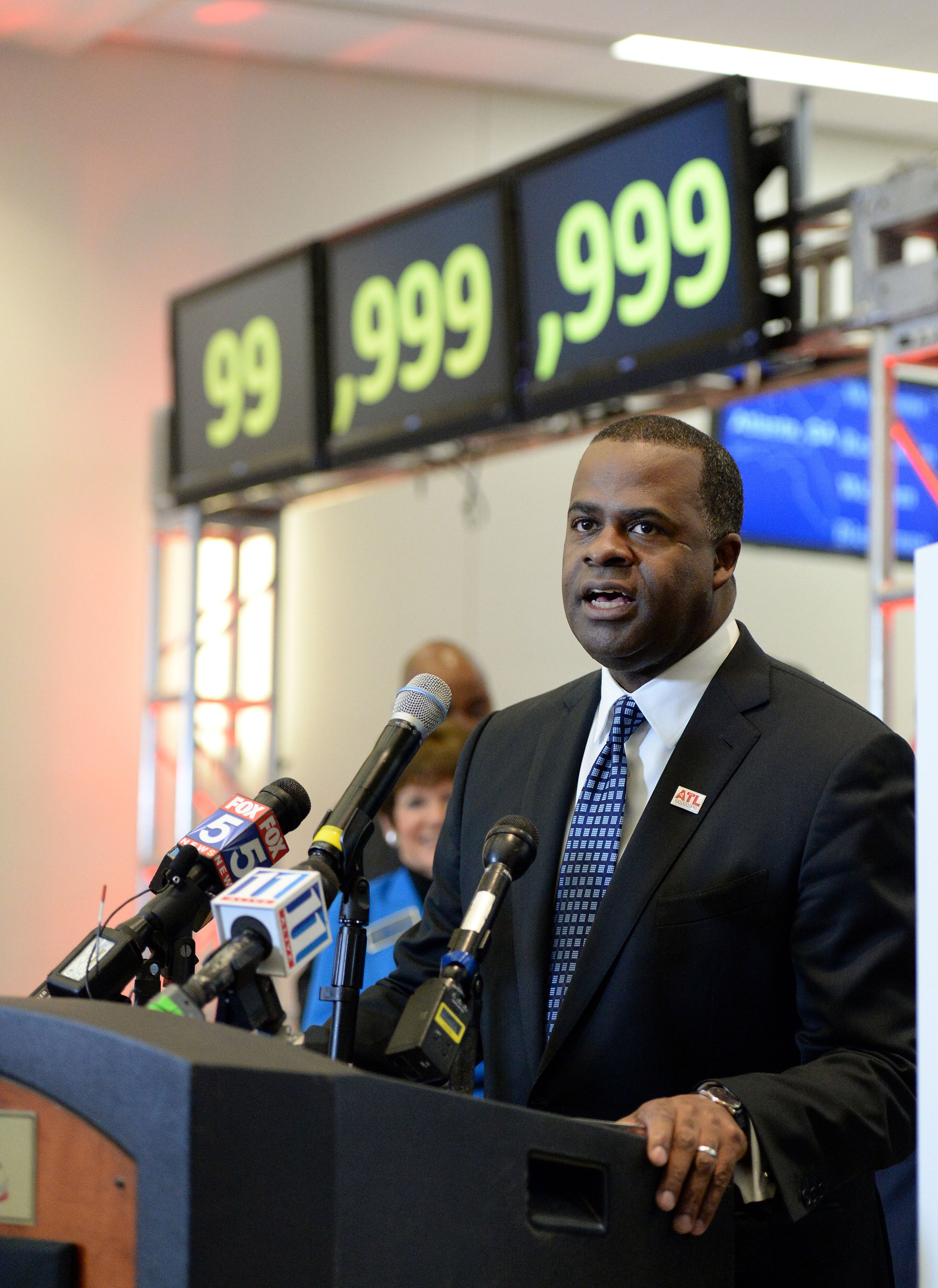 Atlanta Mayor Kasim Reed gives remarks during the ceremony. Hartsfield-Jackson International Airport awarded its 100 millionth passenger for 2015 with prizes including a new car, two free airline tickets and a small crowd of officials and television cameras early Sunday December 27, 2015. The Atlanta airport, "the world's busiest" is the first airport in the world to handle 100 million passengers in a year. "It's our commitment that we maintain our position as the world's most traveled airport," said Atlanta Mayor Kasim Reed during remarks at the airport before the flight arrived Sunday morning. The winner, a man from Biloxi named Larry Kendrick who arrived at the airport in blue jeans, an orange t-shirt and a baseball cap, was surprised to learn upon landing that he had been selected as the 100 millionth passenger. KENT D. JOHNSON/ kdjohnson@ajc.com
