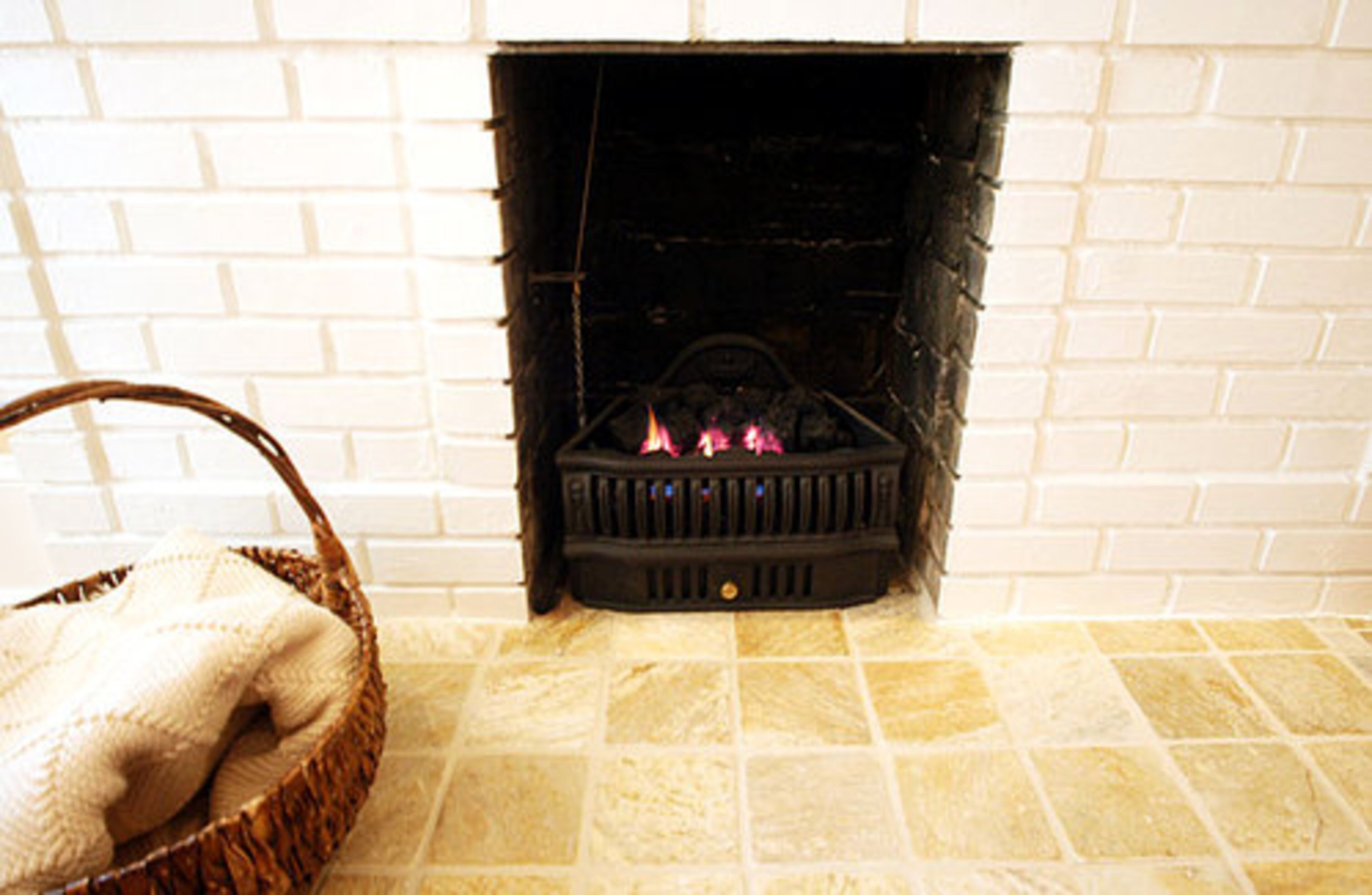 A coal fireplace once heated the home but during renovations, it was replaced with gas coal insert for a modern twist on an old heating system.