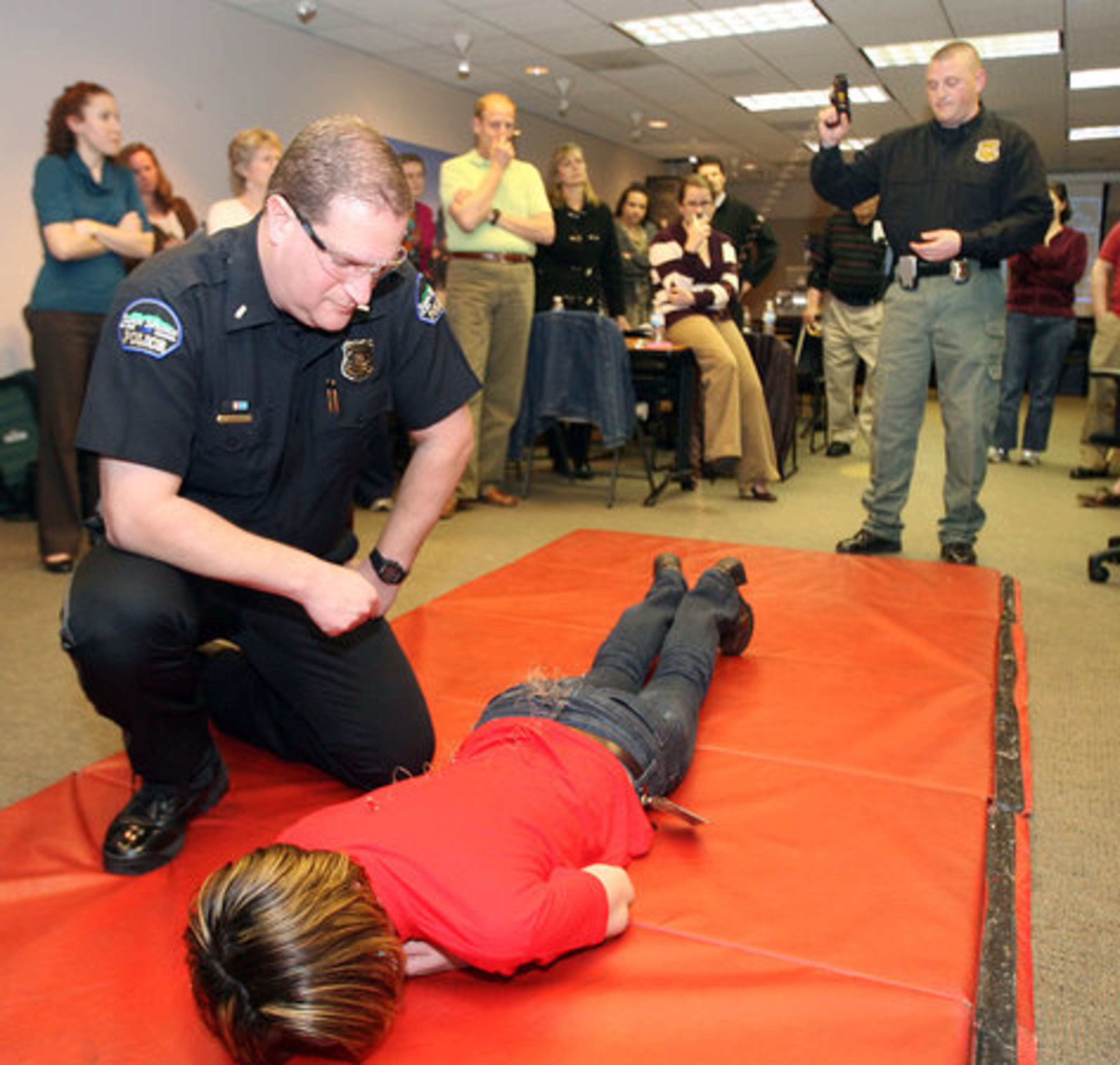 Lt. David Roskind makes sure Paalanen is okay while she recovers from a taser shot by Sgt. Josh Emmett.