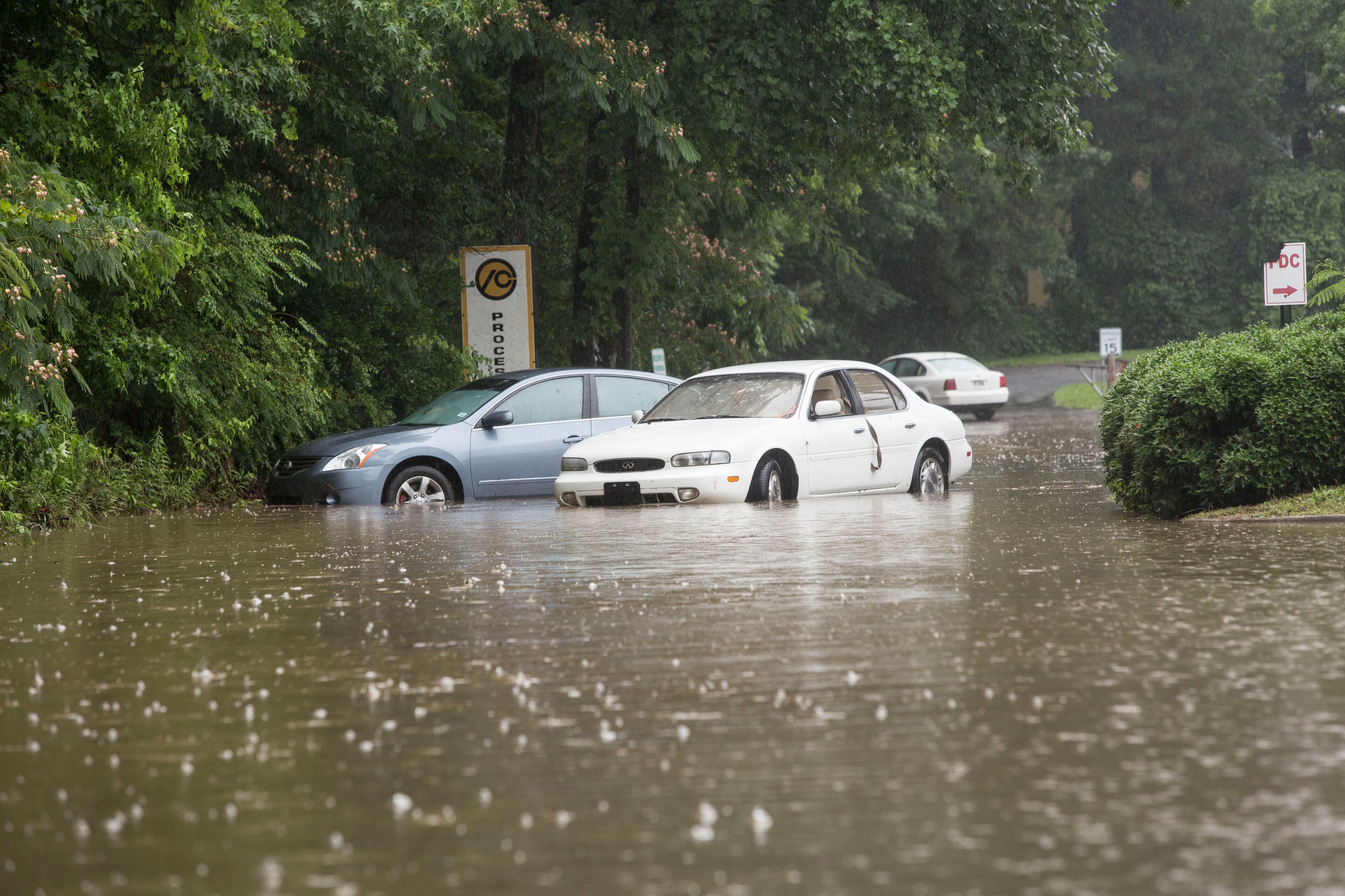 A parking lot on Mimms Drive in Gwinnett County was flooded by heavy rain Tuesday. CHAD RHYM / CHAD.RHYM@AJC.COM