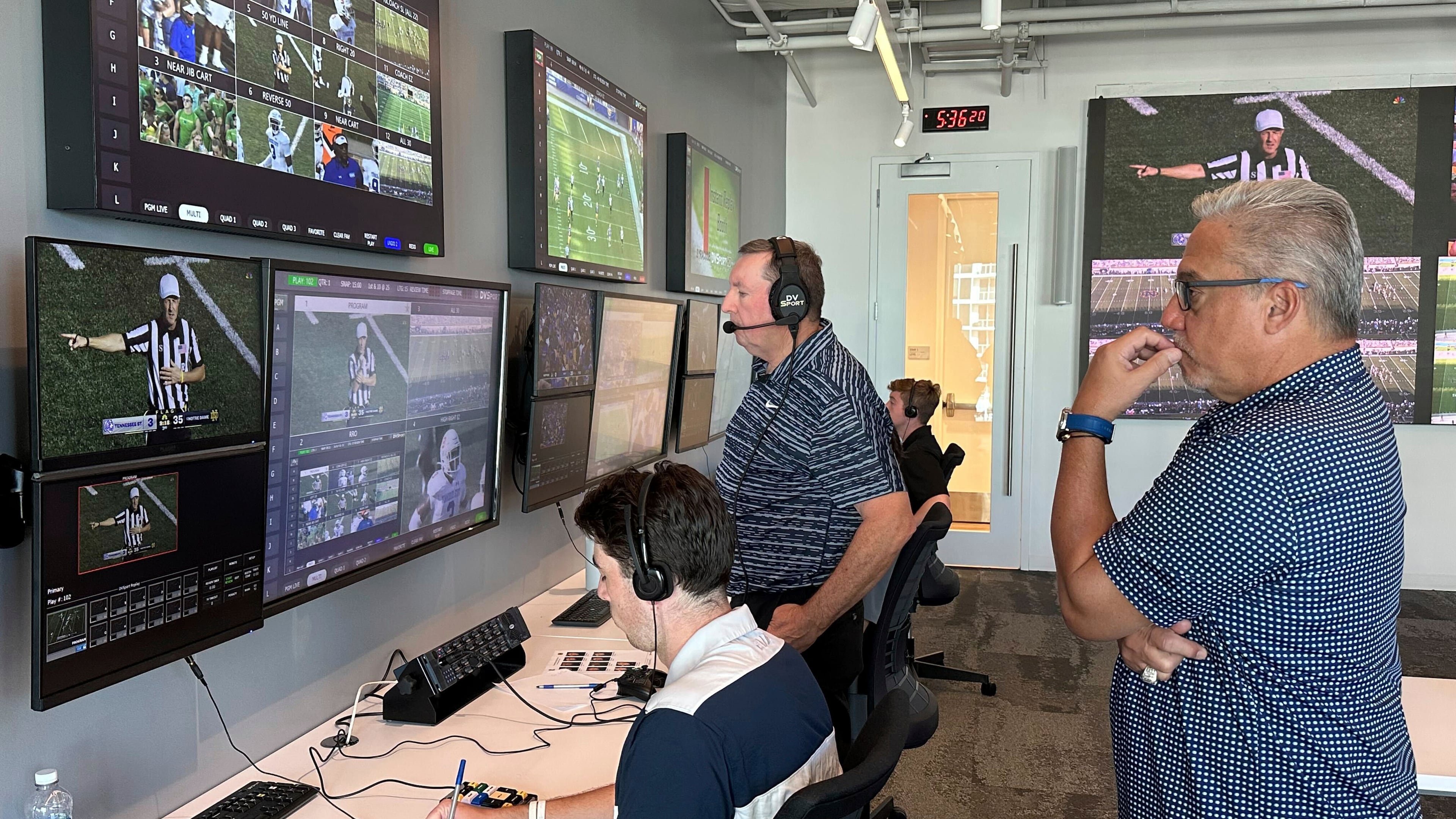 FILE - Alberto Riveron, right, the Atlantic Coast Conference supervisor of football officials, works in the league's new gameday operations center, Saturday, Sept. 2, 2023, in Charlotte, N.C. (AP Photo/Aaron Beard, File)