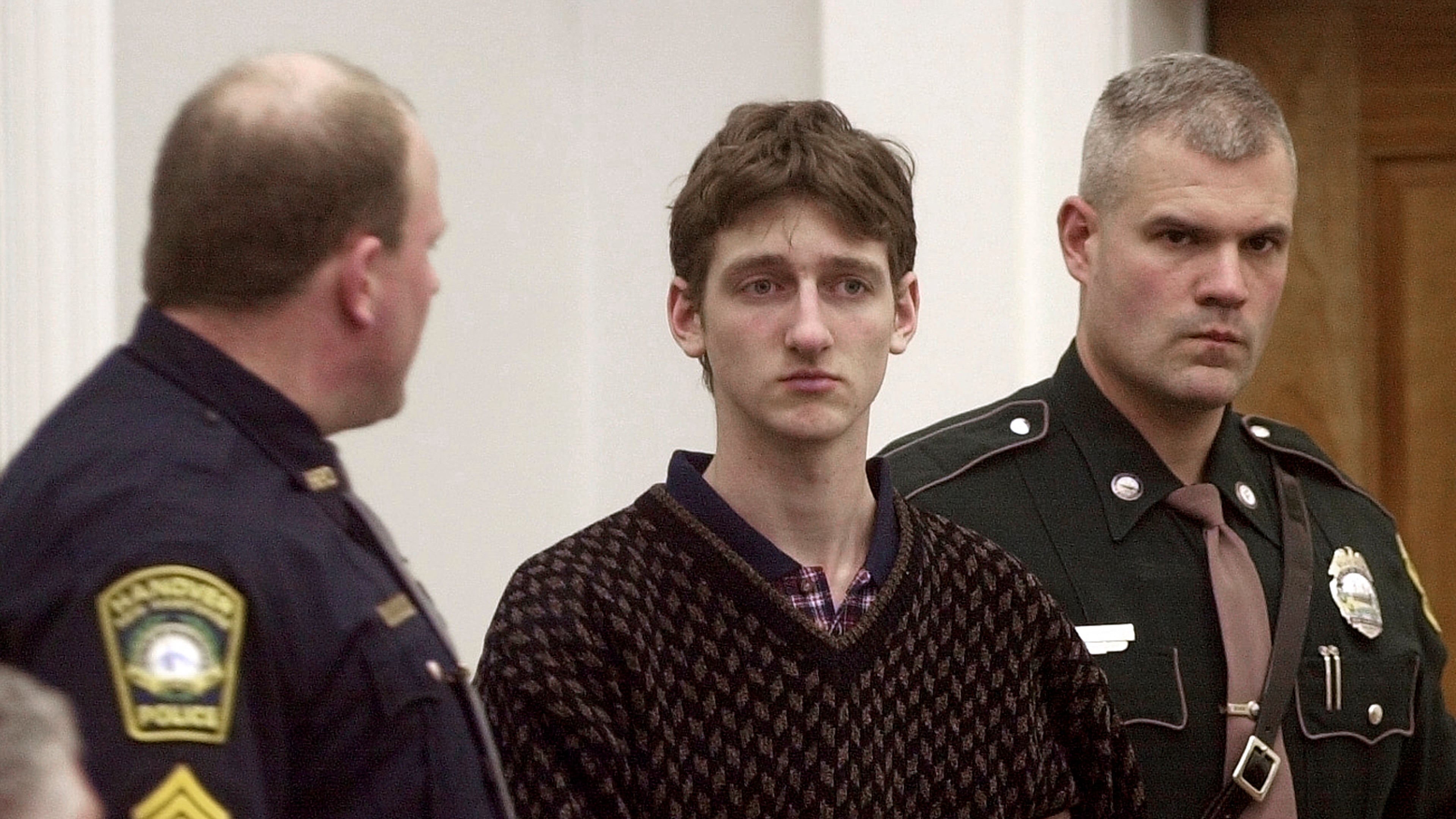 FILE - Robert Tulloch, 17, is escorted into Lebanon, N.H. District Court by Tropper James Stienmetz, right, and Hanover Sgt. Jeffrey Fleury, Feb. 21, 2001. (AP Photo/Jim Cole, File)