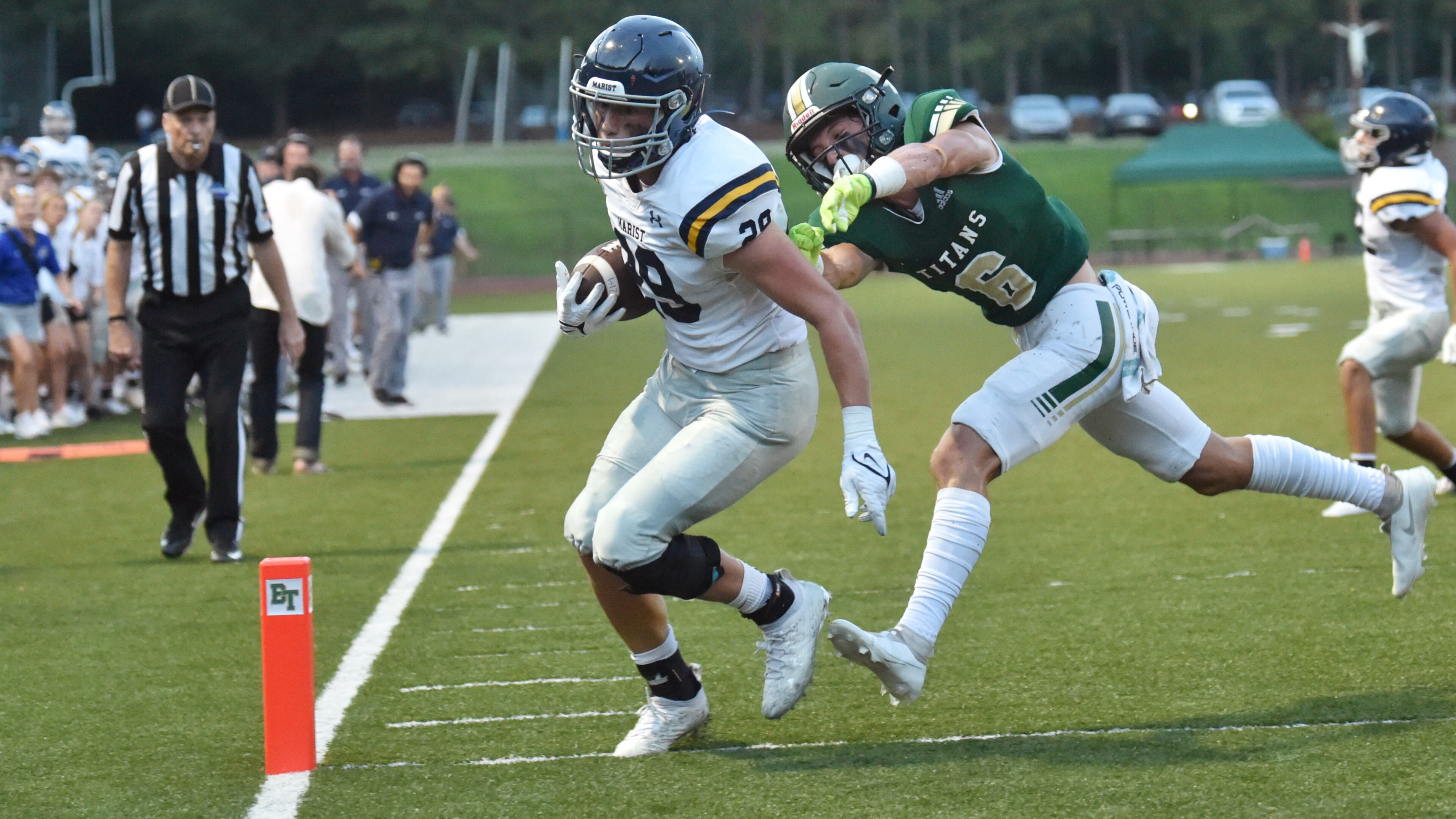 Marist running back Quinn Gooding (29) scores a touchdown past Blessed Trinity's Ashton Abrew (6) in the first half at Blessed Trinity Catholic High School in Roswell on Friday, August 27, 2021. (Hyosub Shin / Hyosub.Shin@ajc.com)