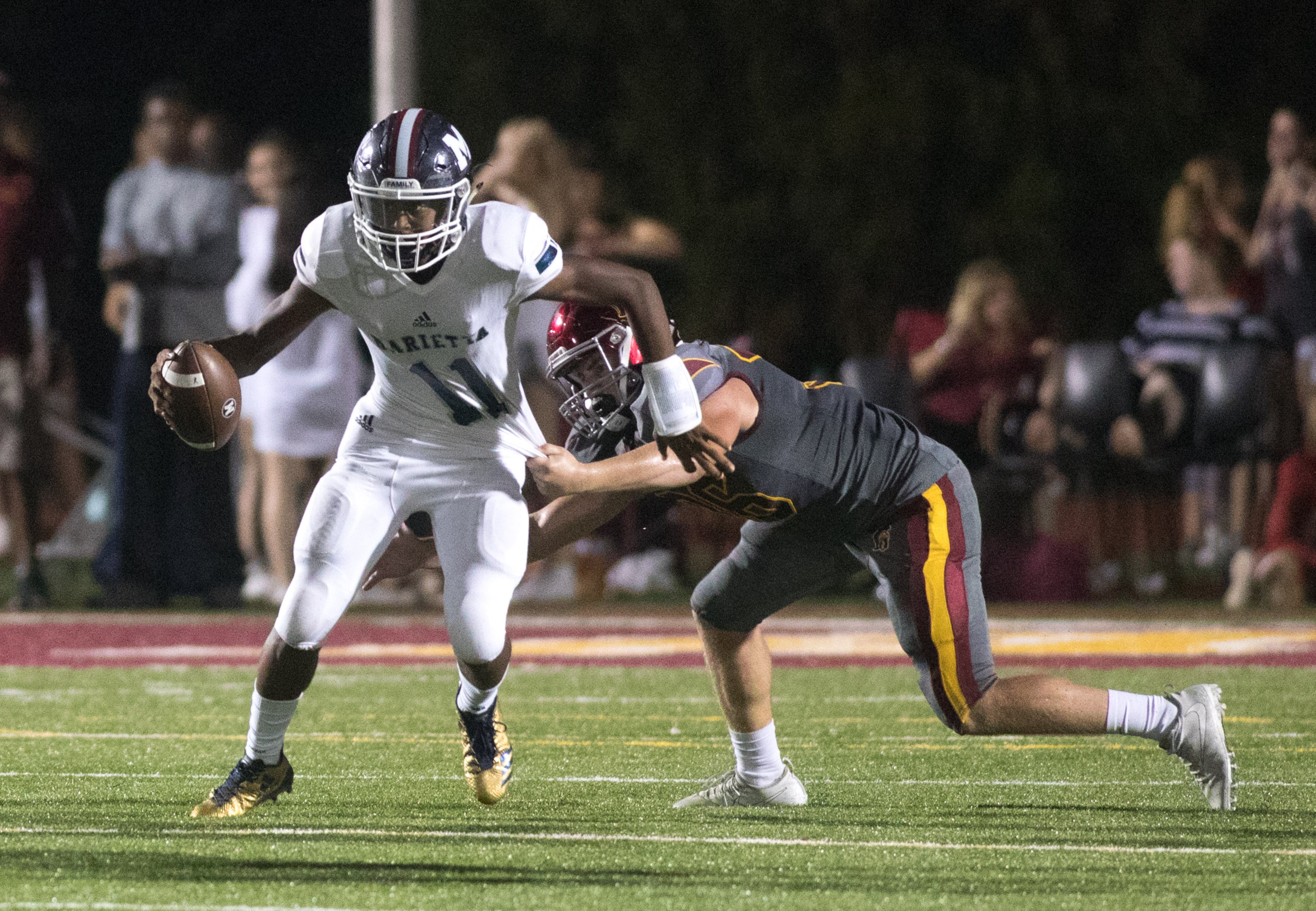 Marietta High School quarterback Rashun Bass (11) is stopped by Lassiter High School's Owen Fritz (36) during the second half of a high school football game, Friday, Sept. 15, 2017, in Marietta, Ga. BRANDEN CAMP/SPECIAL