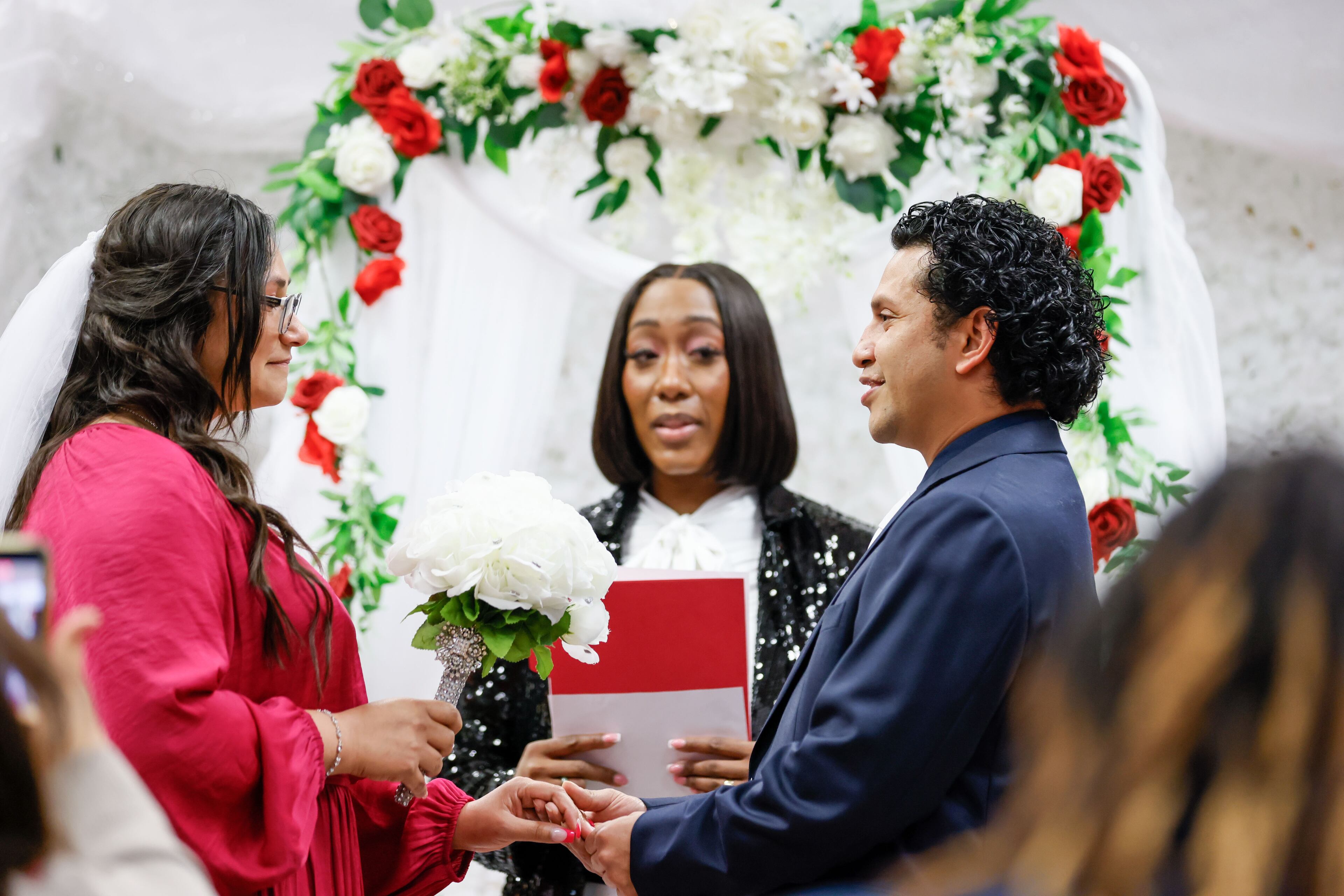 Crosby Pavon holds hands with Ashley Morales as they exchange vows during Valentine’s Day Free Weddings at the Fulton County Probate Court on Wednesday, Feb. 14, 2024, in Atlanta.
Miguel Martinez /miguel.martinezjimenez@ajc.com