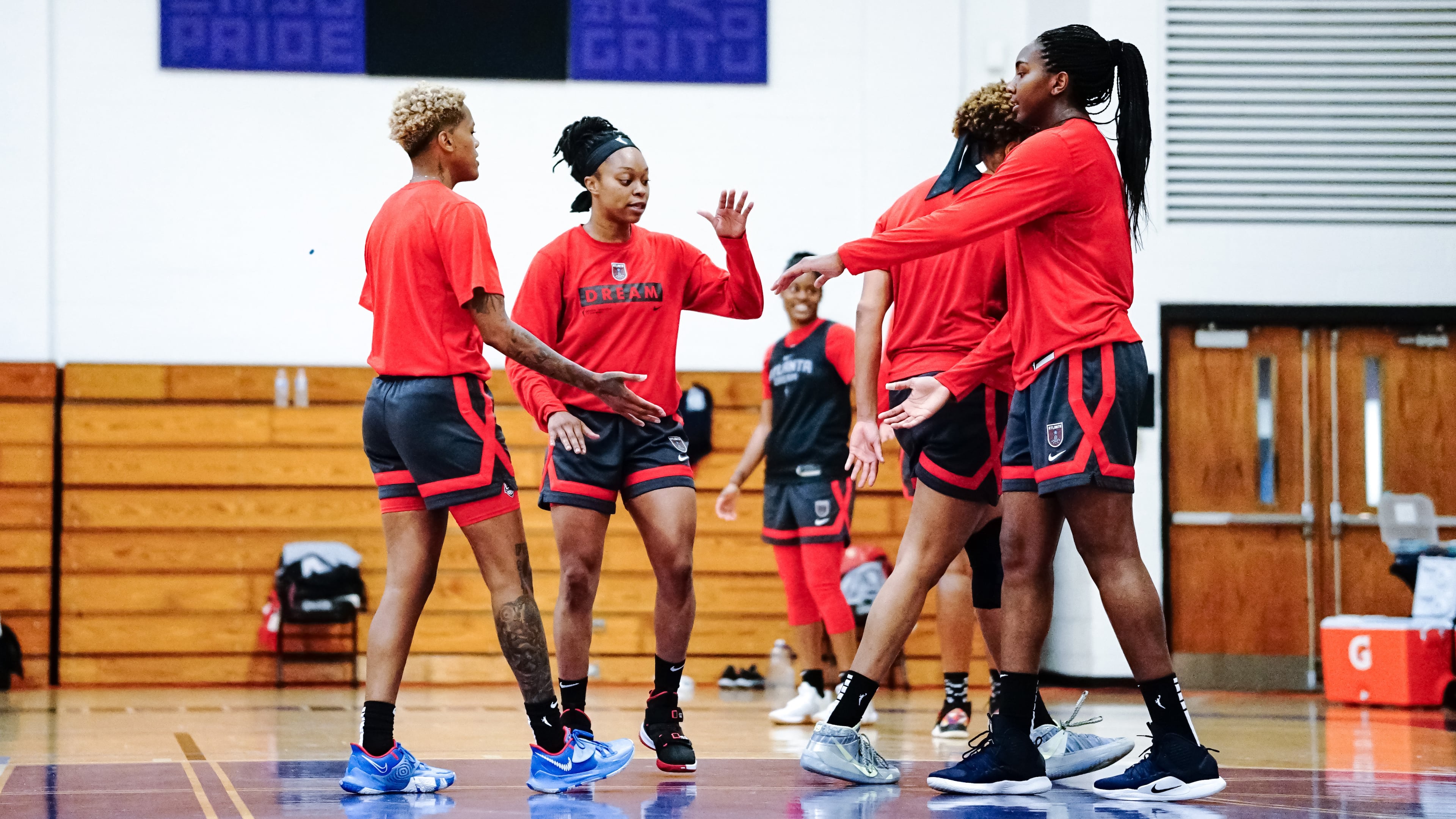 Atlanta Dream guard Odyssey Sims interacts with teammates during training camp.